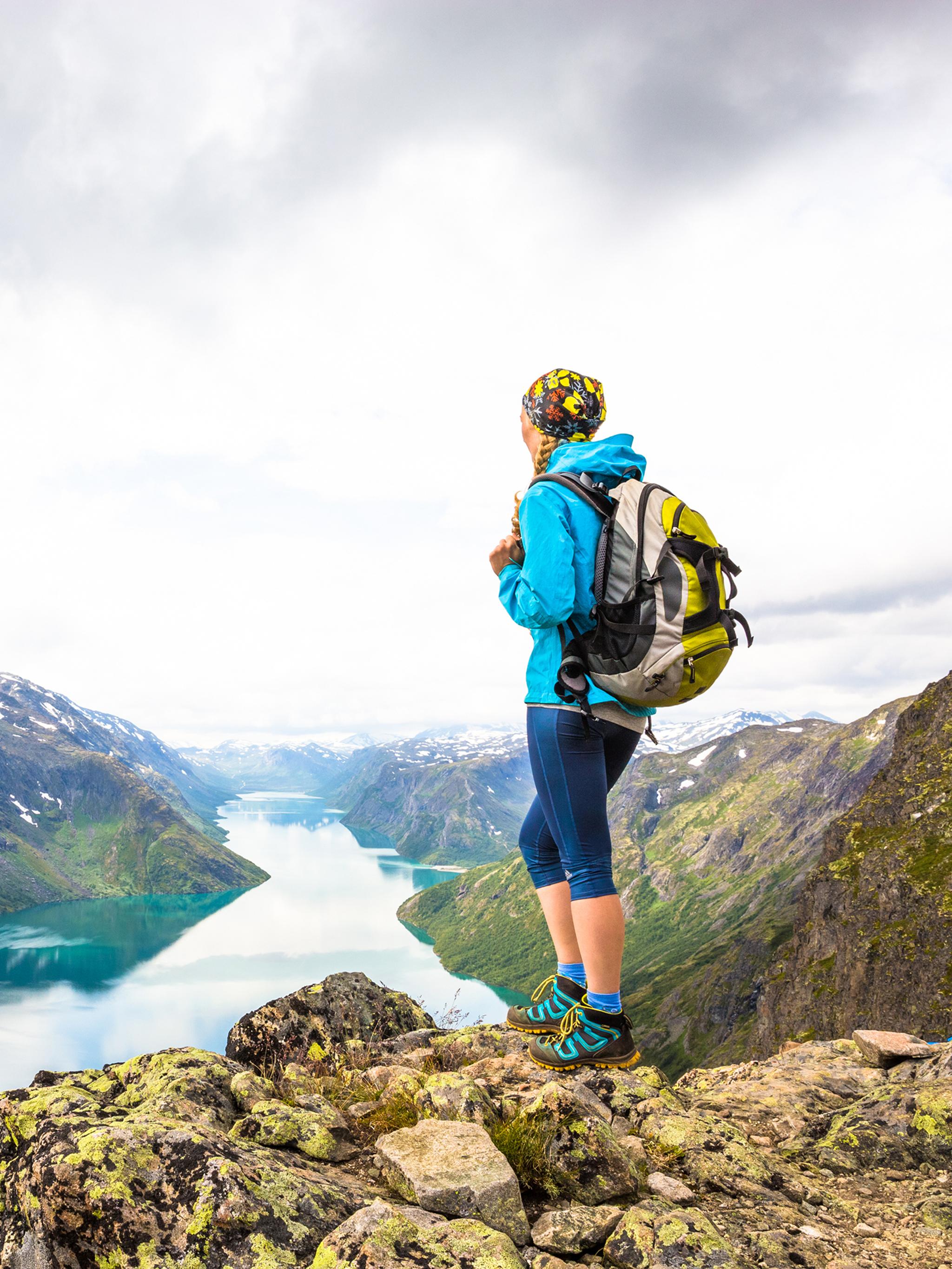 A woman enjoying the view of Lake Gjende from the top of Besseggen in Jotunheimen, Eastern Norway