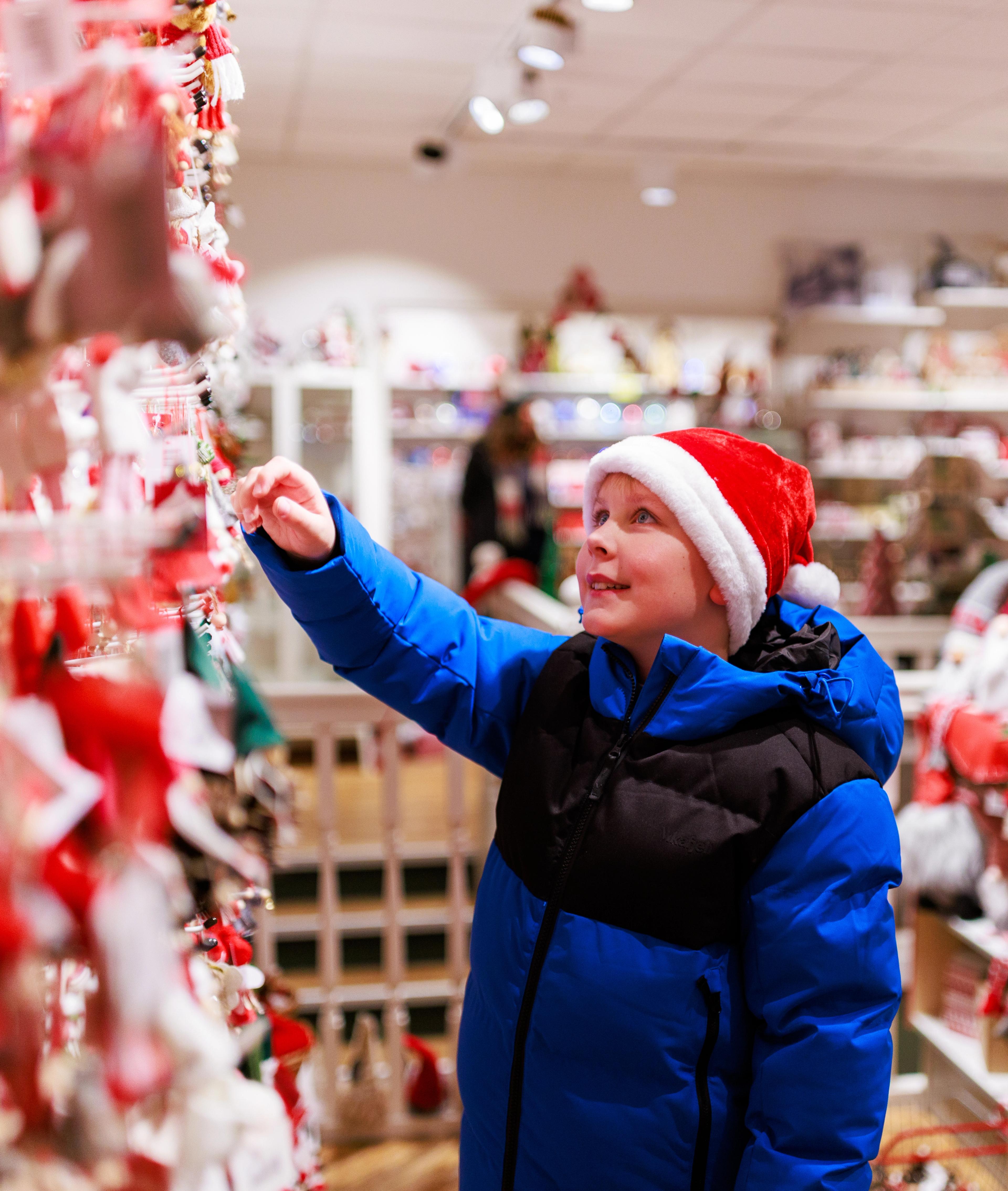Boy looking at Christmas ornaments at the Christmas store Audhild Viken in Stavanger