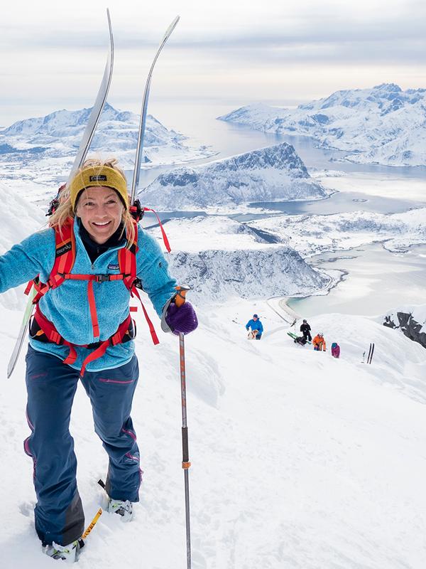 Woman climbing mount Himmeltind on a ski touring trip in Lofoten, Northern Norway