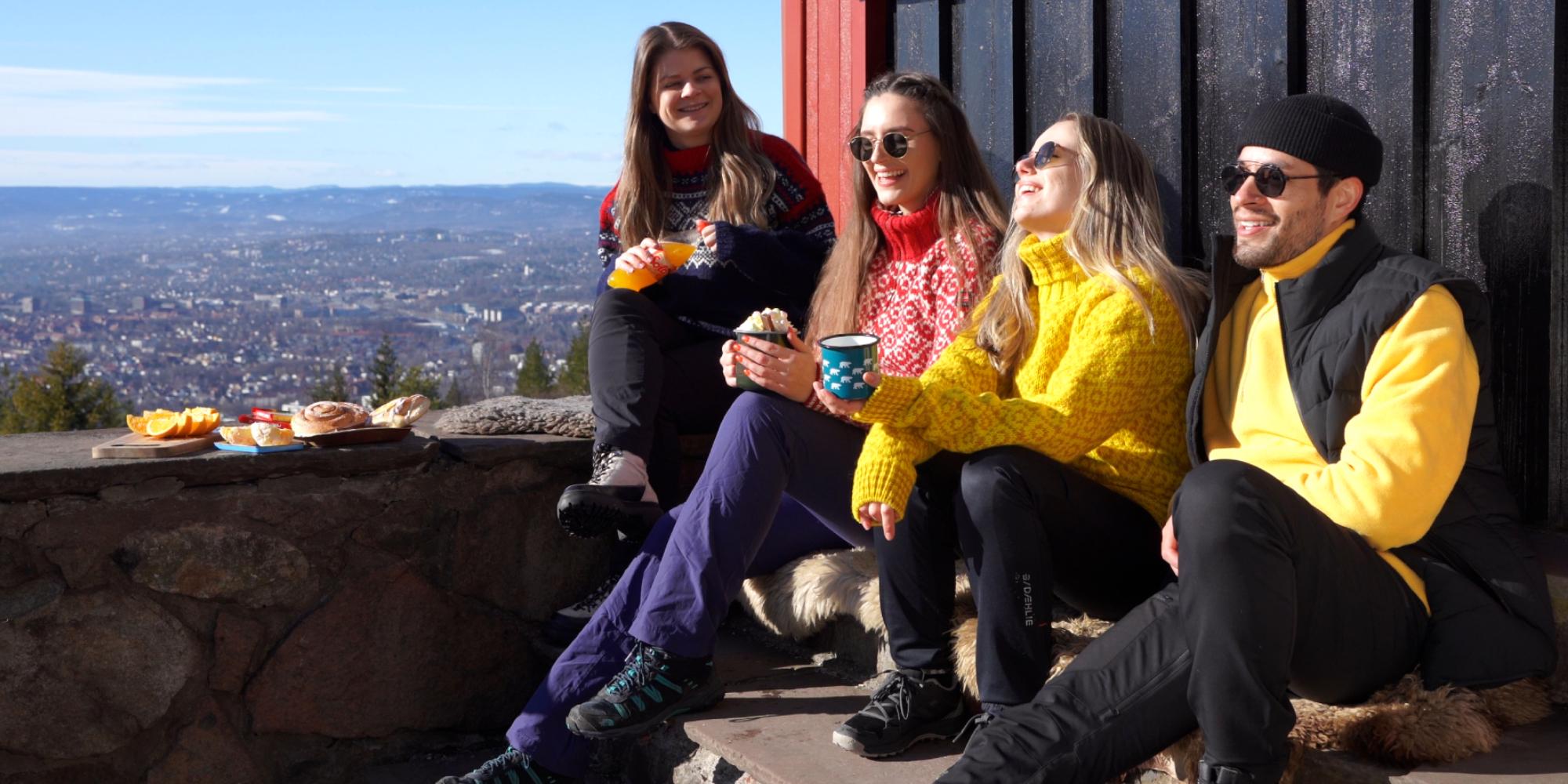 Friends sitting in a sun-facing wall at Grefsenkollen restaurant