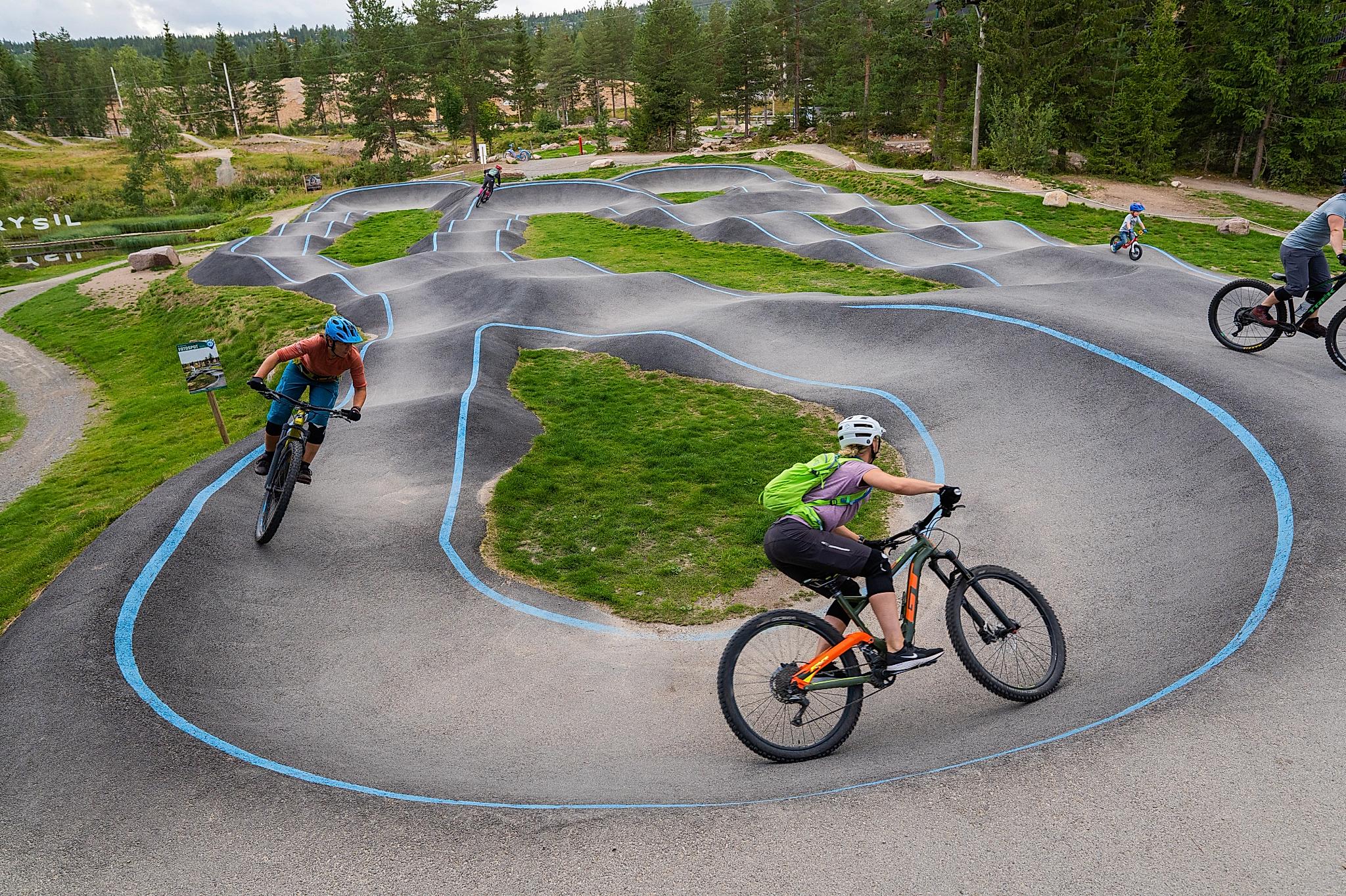 People mountain biking on a concrete track.