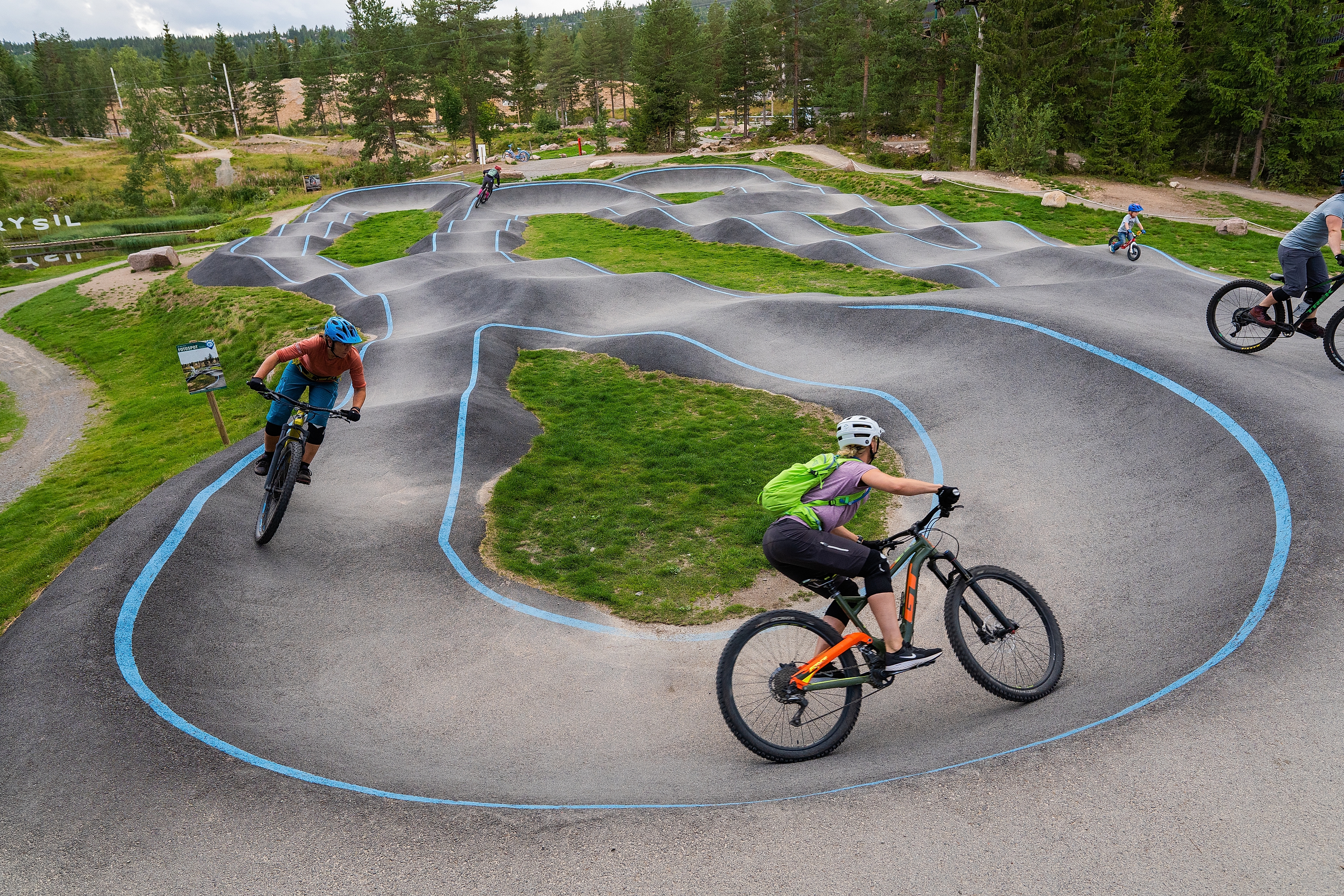 People mountain biking on a concrete track.