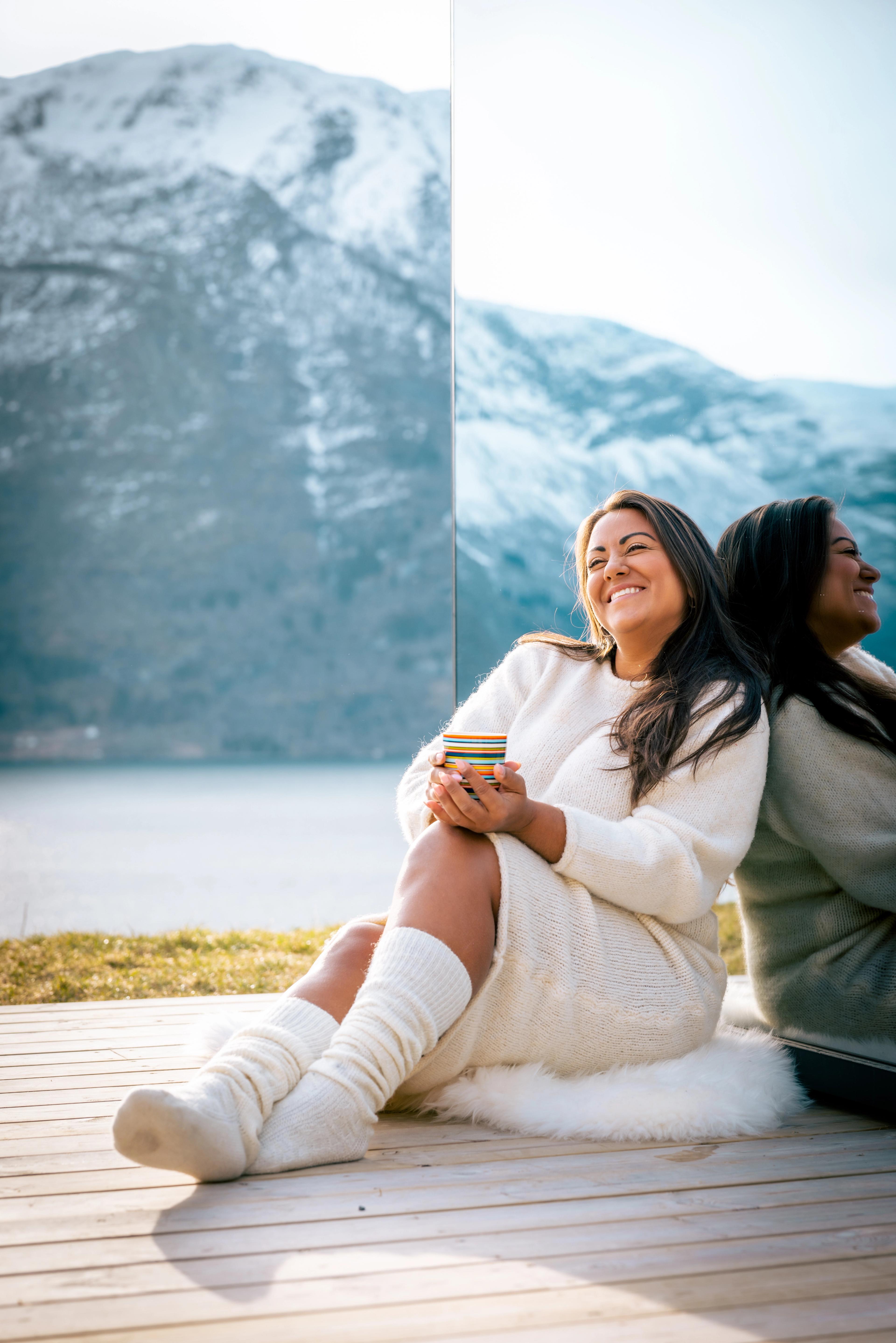 Woman outside of the The Fjord Mirror - Panoramic view of Lustrafjorden