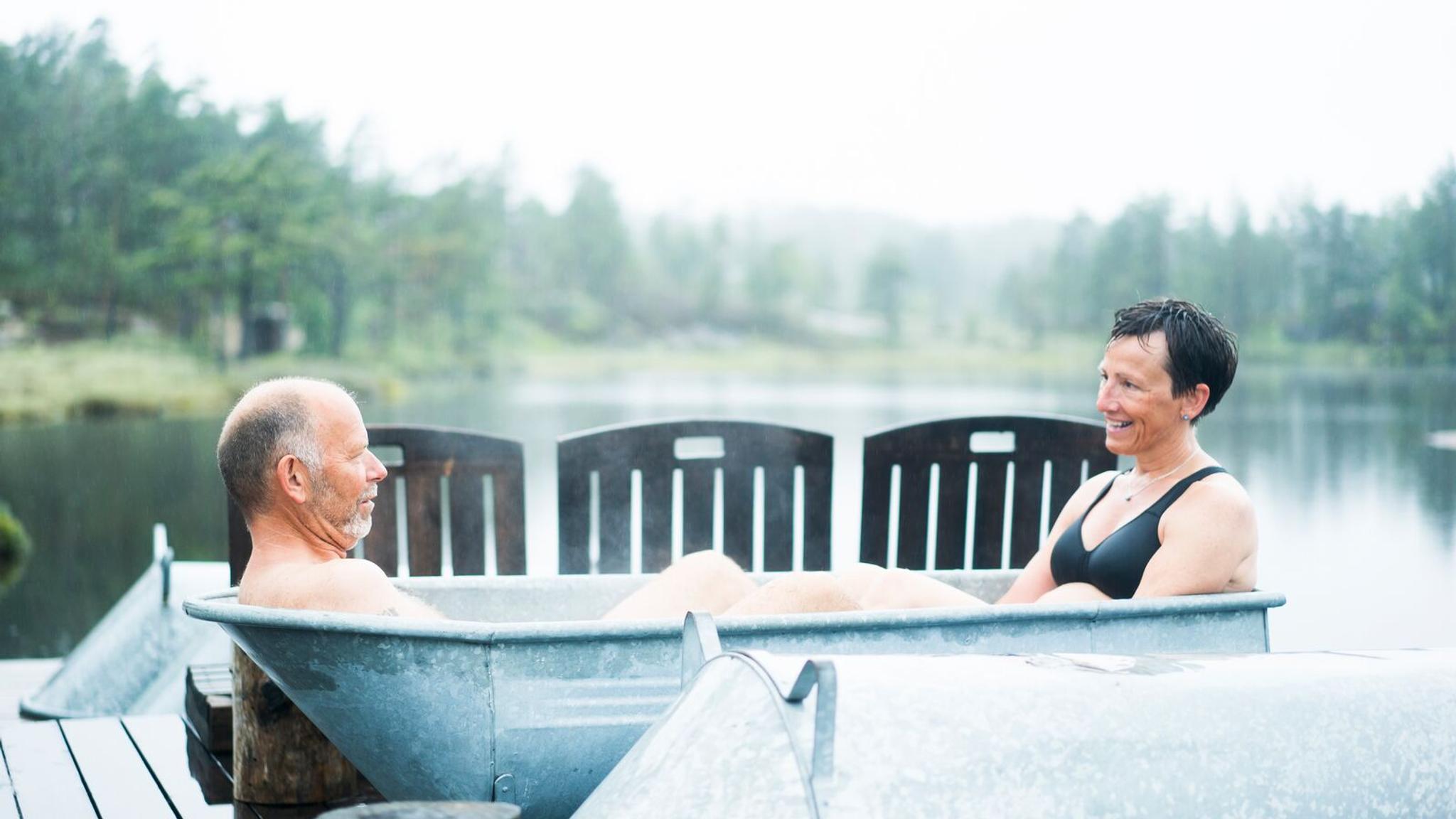Two people relaxing in a bath tube at Canvas Hotel's spa, Norway.