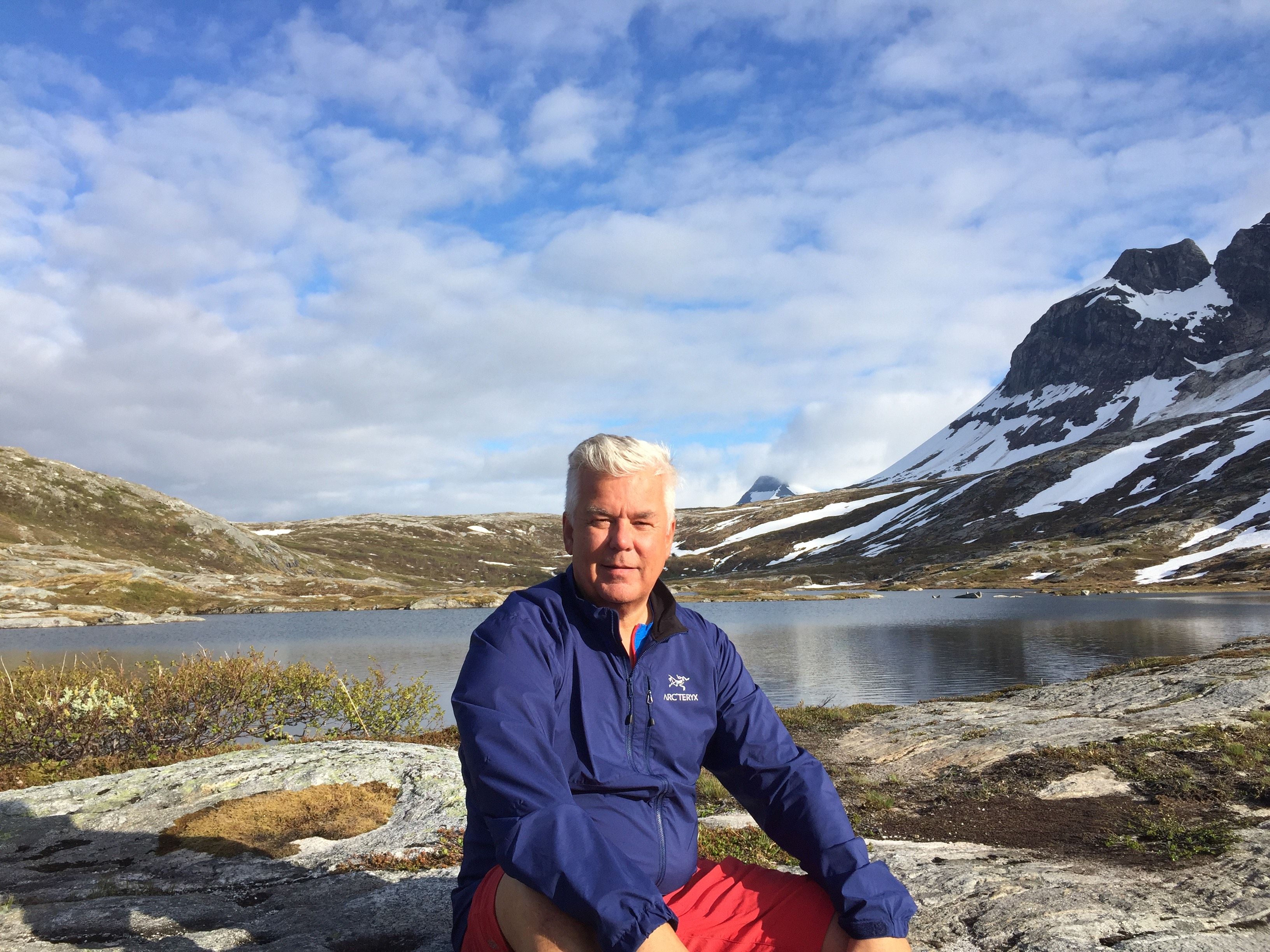 Bjørn Heitmann sitting by mountain lake, Bodø Northern Norway