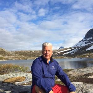 Bjørn Heitmann sitting by mountain lake, Bodø Northern Norway