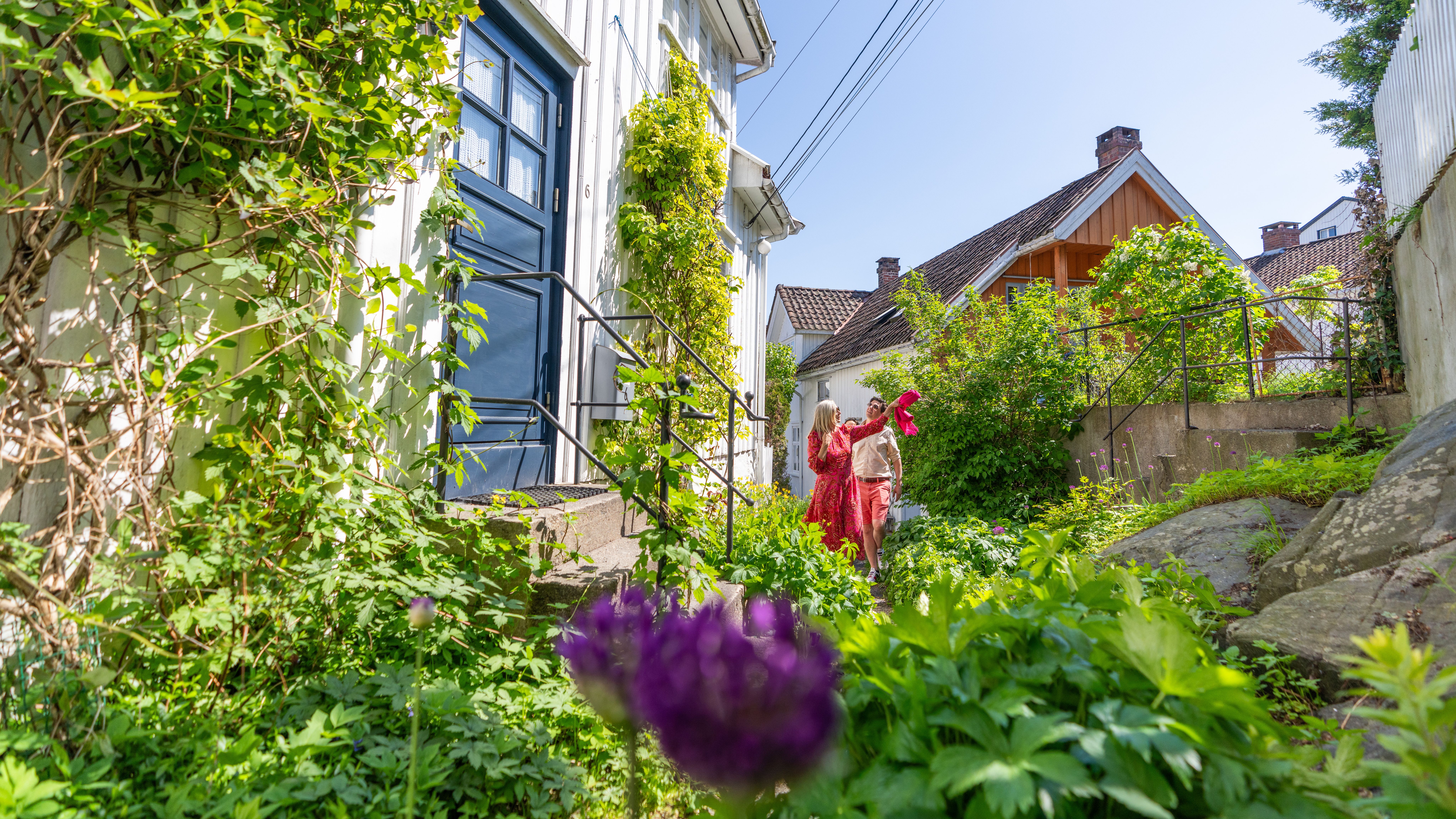 Sightseeing through narrow alley between wooden houses in Risør, Southern Norway