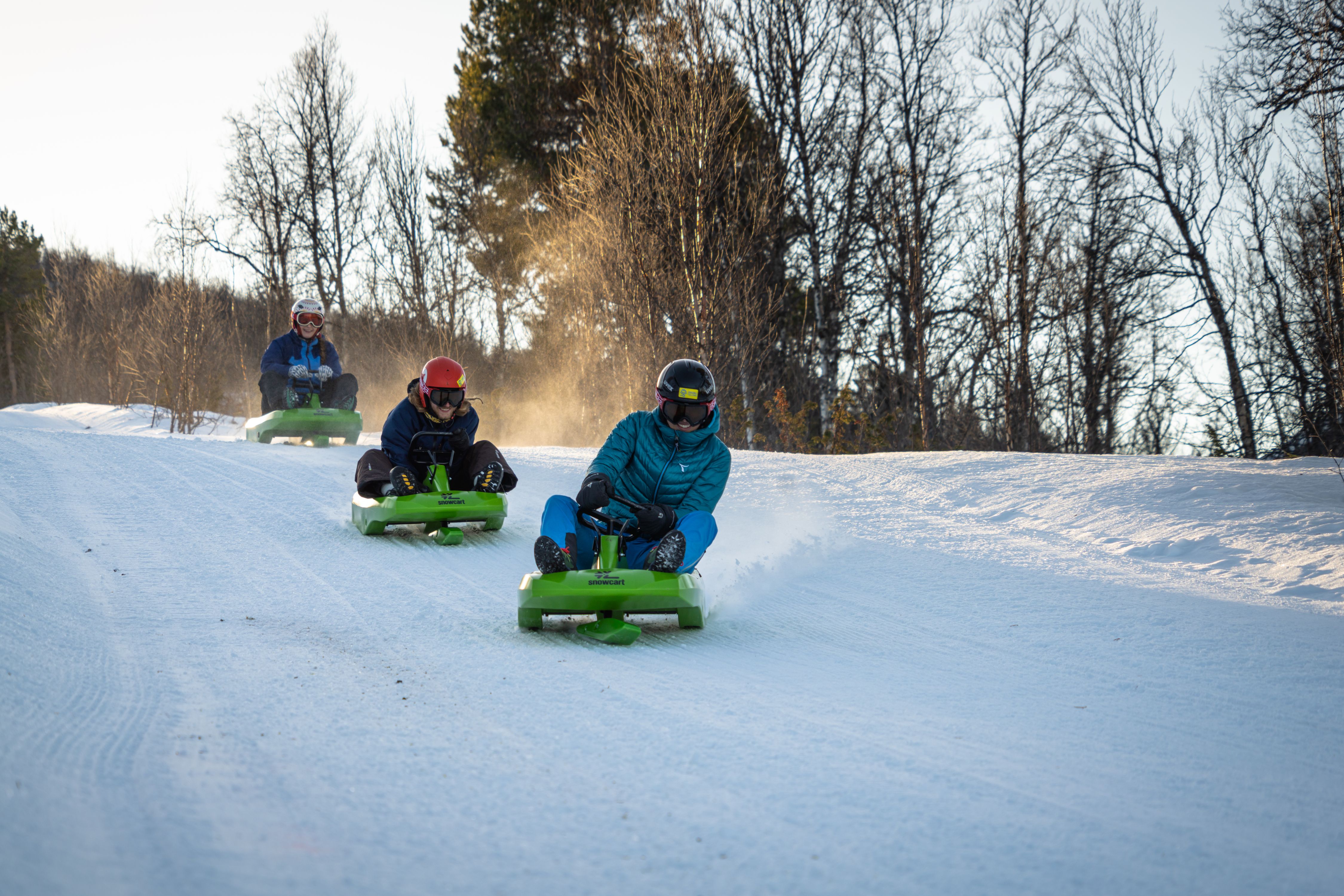 Friends going tobogganing at Dagali Fjellpark, Eastern Norway.