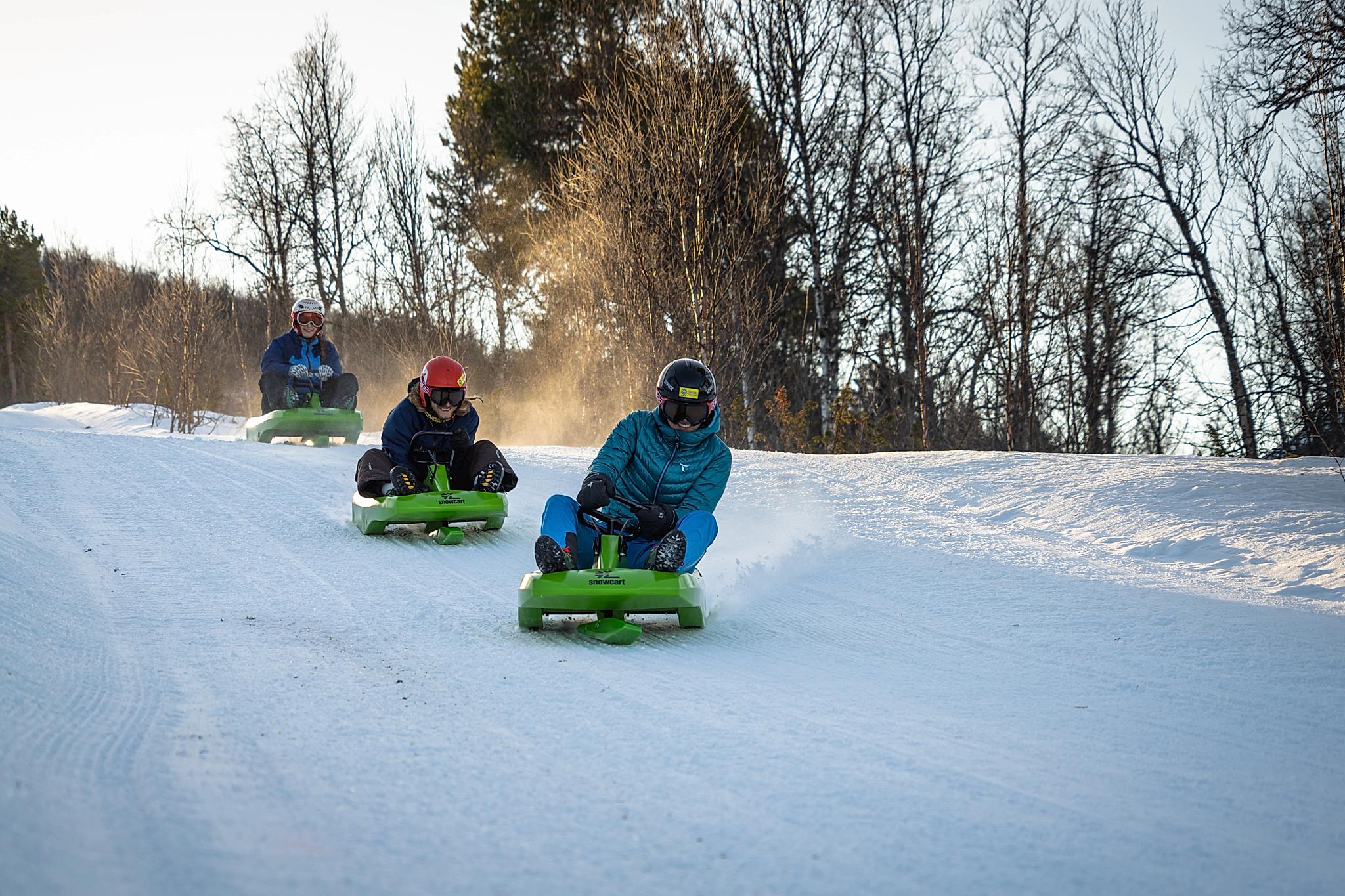 Friends going tobogganing at Dagali Fjellpark, Eastern Norway.