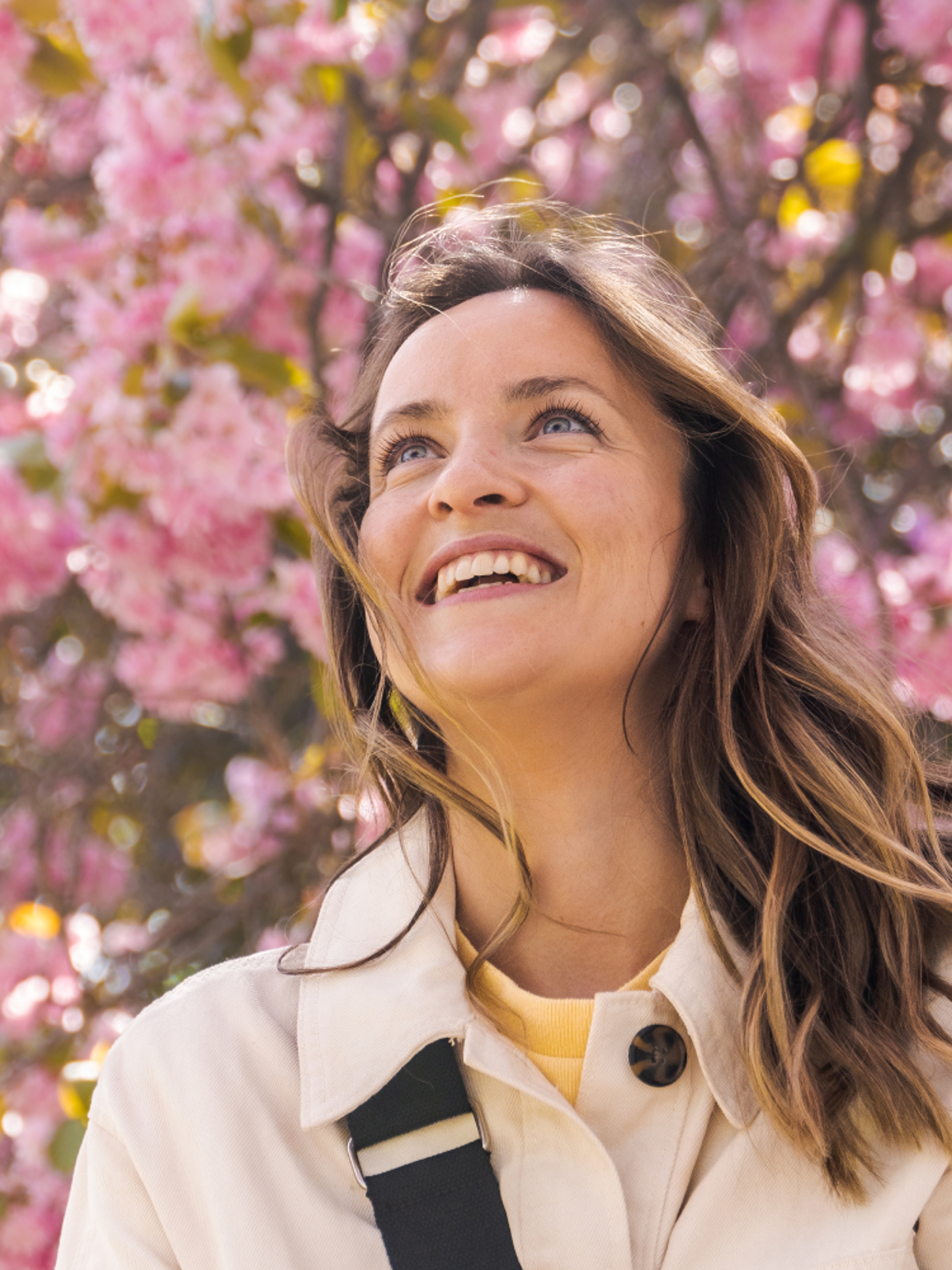 Woman under a pink cherry tree in the Botanic garden at Tøyen in Oslo, Eastern Norway