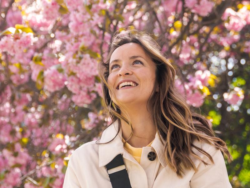 Woman under a pink cherry tree in the Botanic garden at Tøyen in Oslo, Eastern Norway