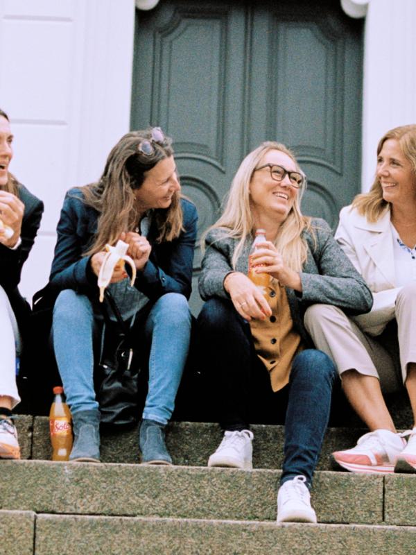 Four women sitting on stairs