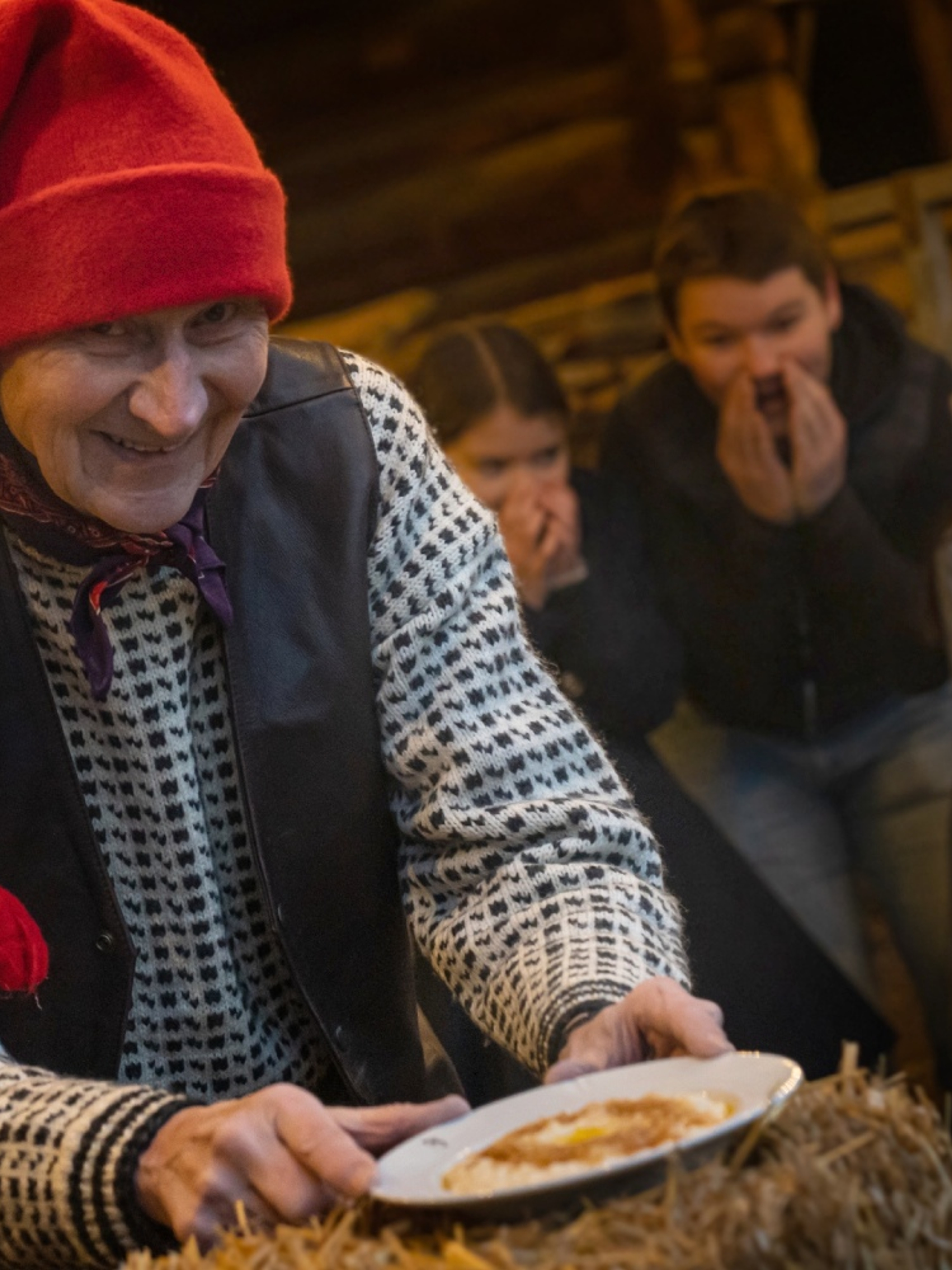 The Norwegian Santa is getting a hold of the porridge, while children is excited in the background at Bygdøy, Eastern Norway