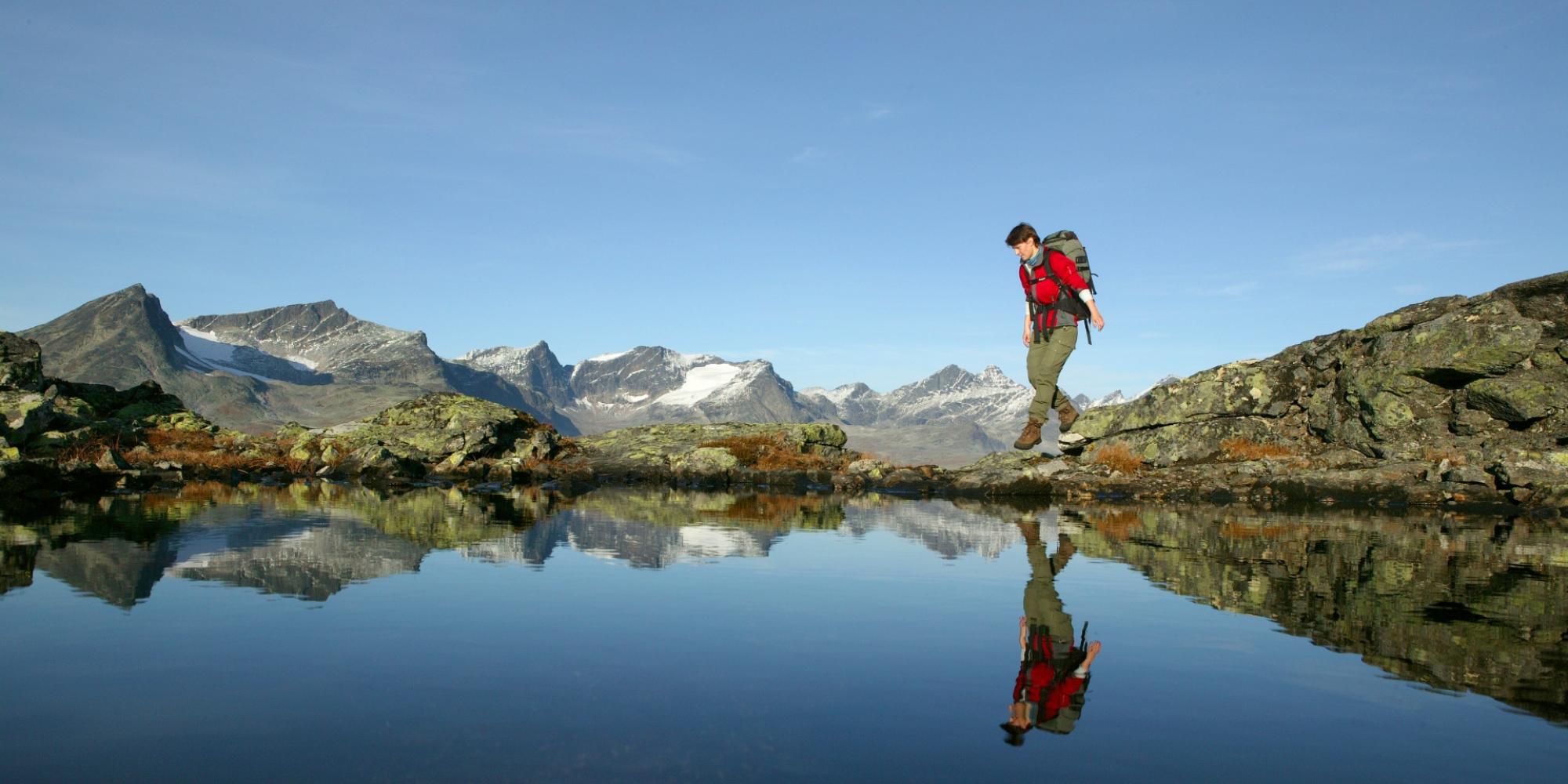 Woman walking the Besseggen ridge in Valdres
