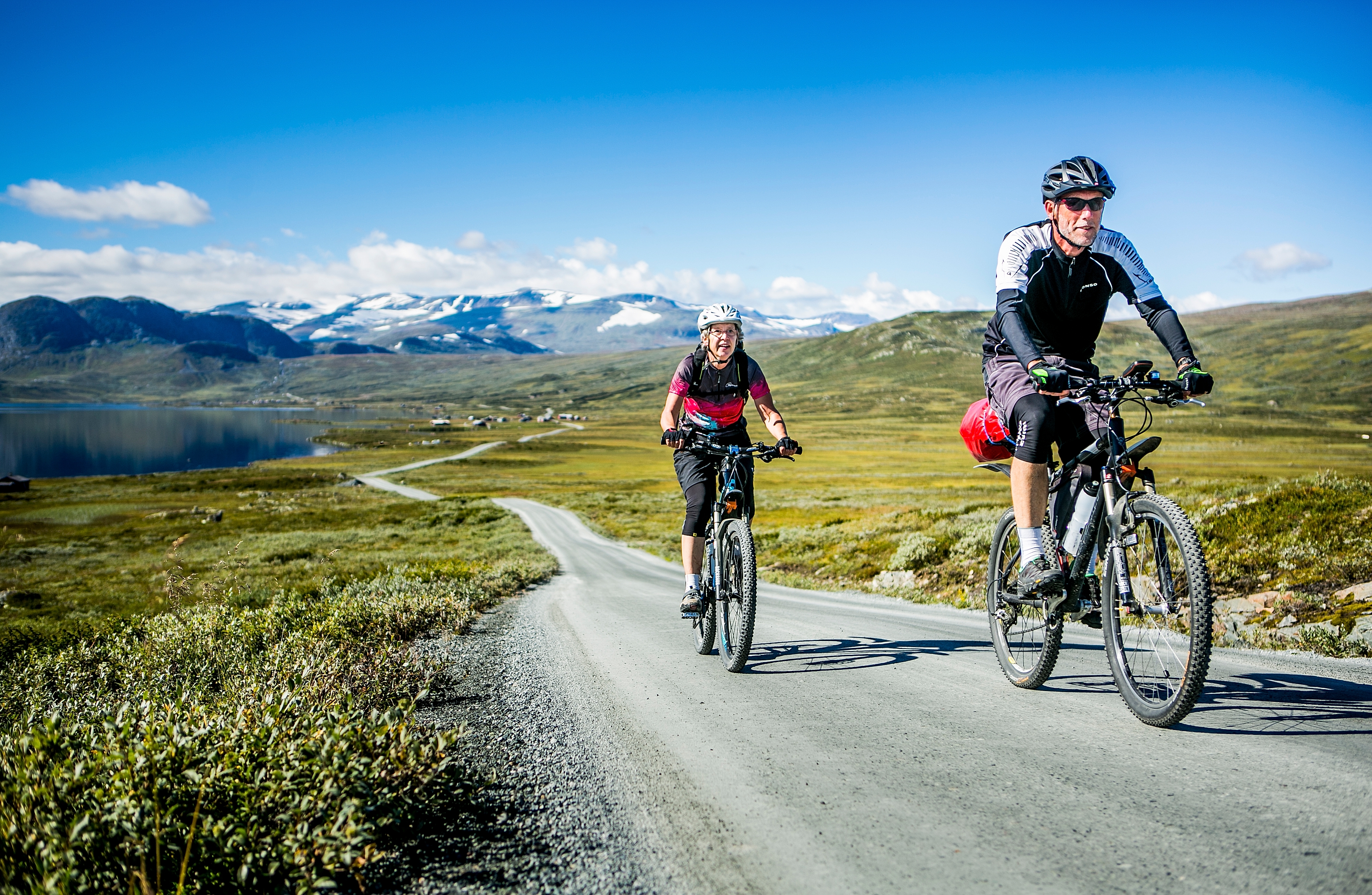 A couple tour cycling the Mjølkevegen bike route in Valdres, Eastern Norway