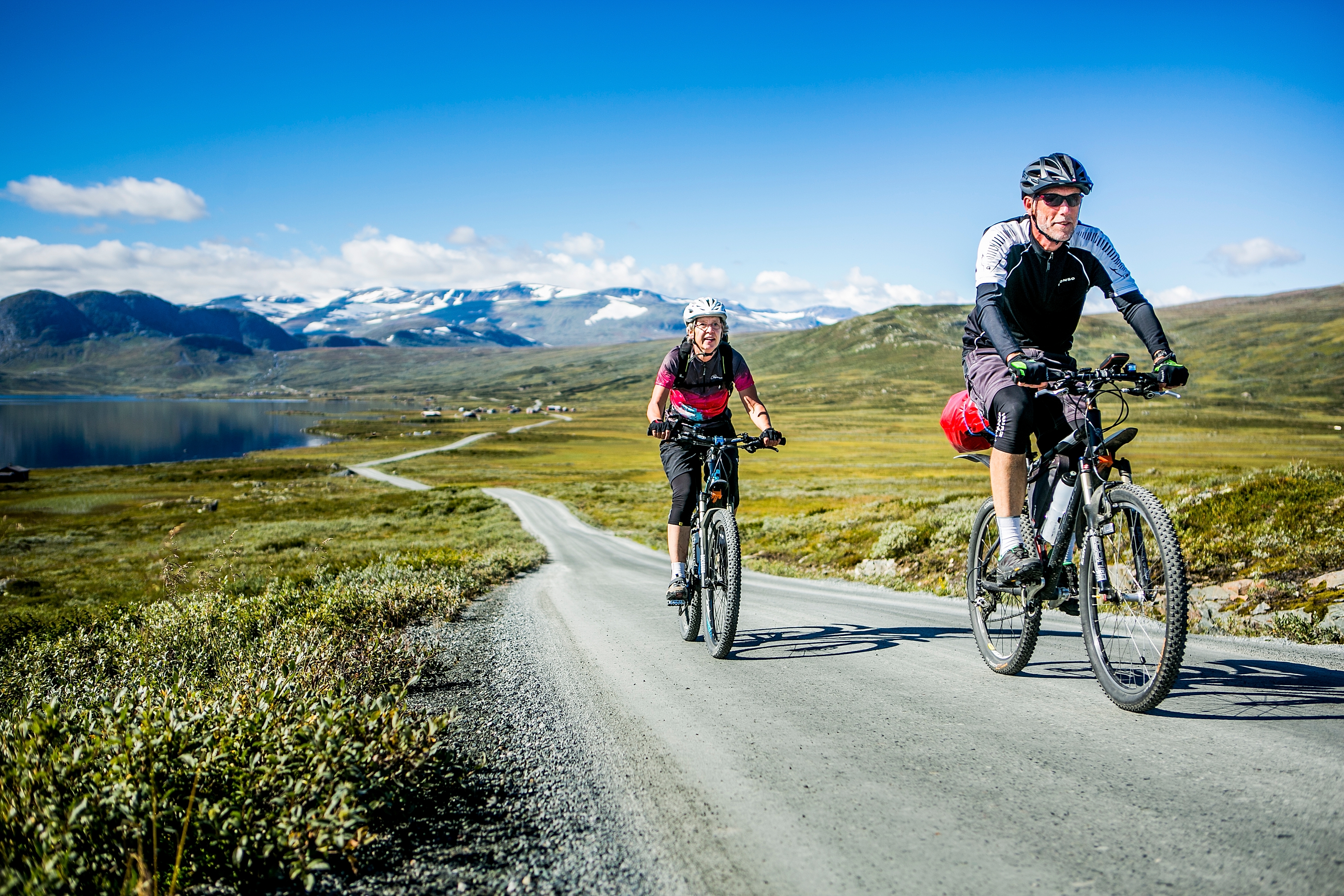 A couple tour cycling the Mjølkevegen bike route in Valdres, Eastern Norway