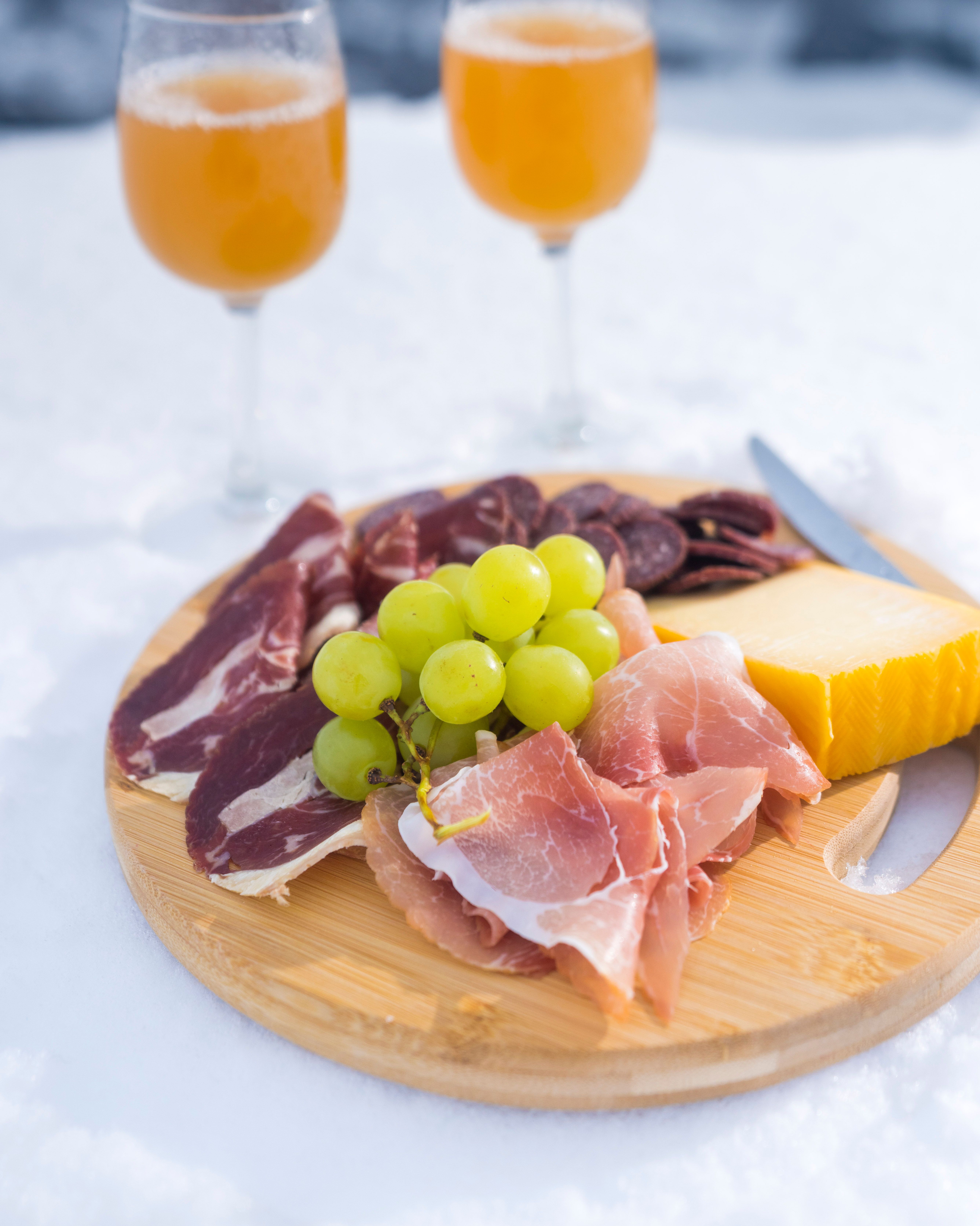 Local ham, cheese and cider from Stranda on a plate in the snow