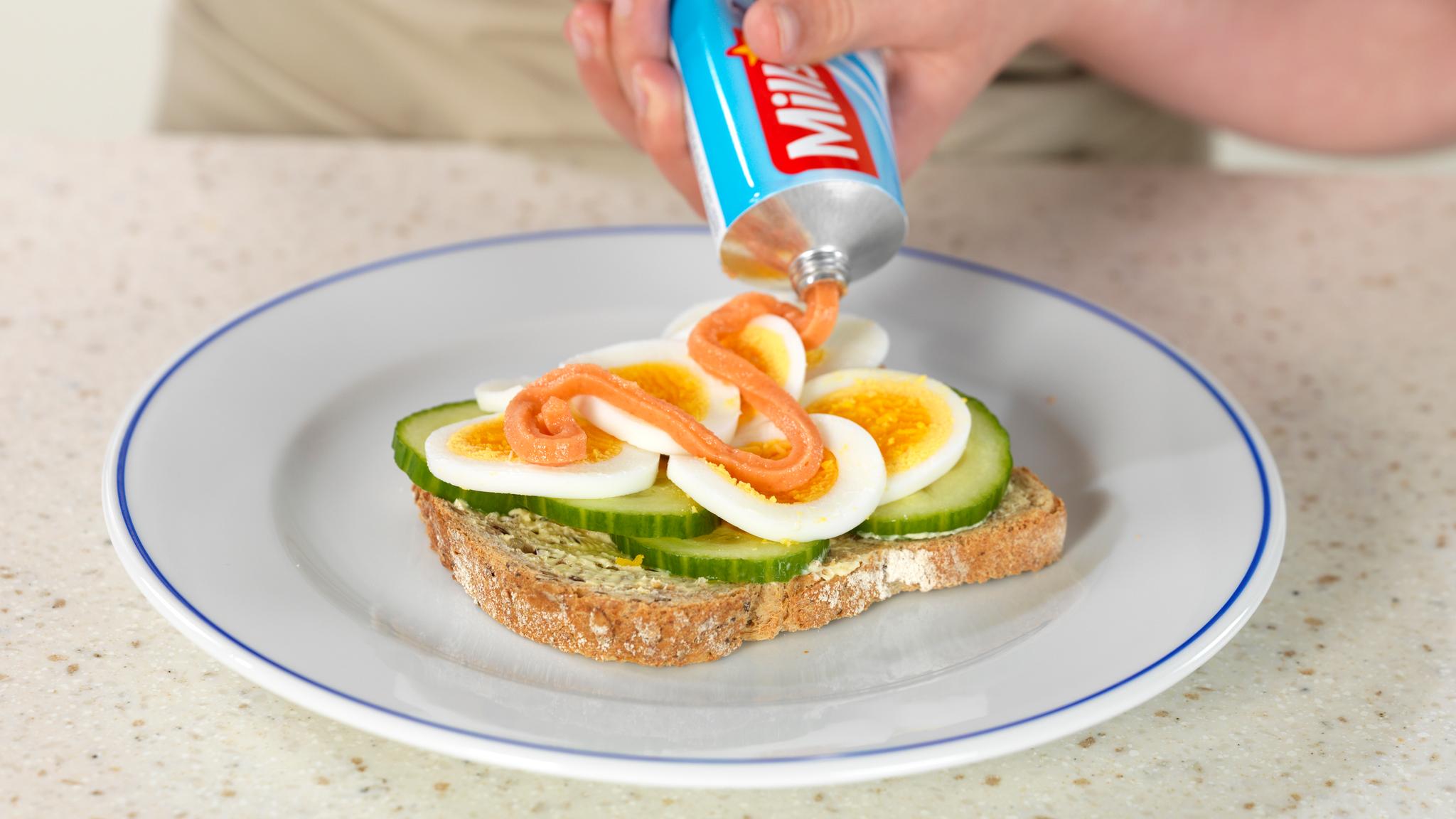 Norwegian caviar, or smoked cod roe, on tube, used as topping on a slice of bread with eggs