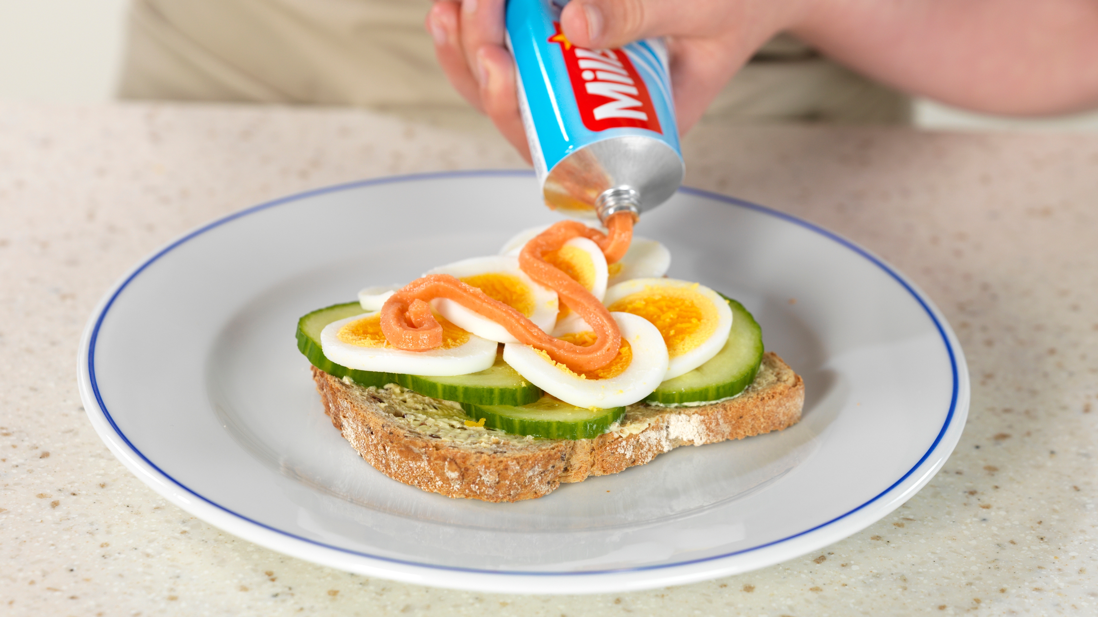 Norwegian caviar, or smoked cod roe, on tube, used as topping on a slice of bread with eggs