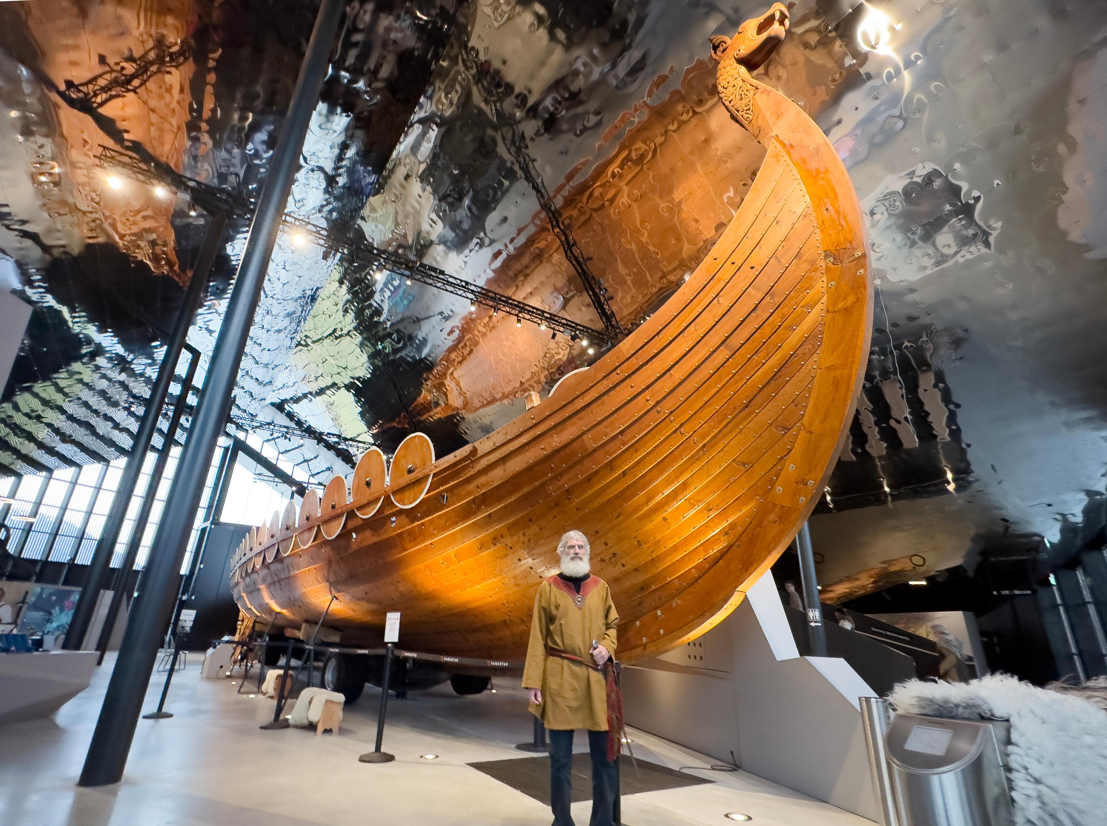A male viking in front of the Myklebust Viking ship at the Sagastad Viking Centre in Nordfjord