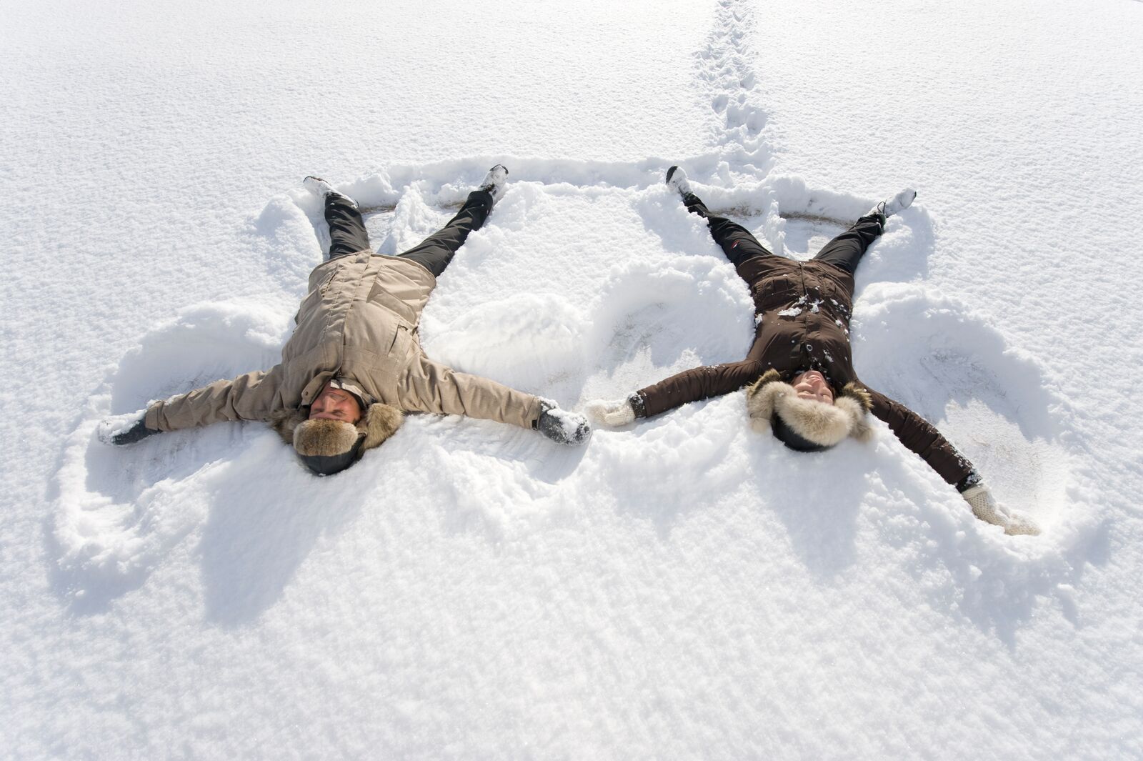 Two people playing in the snow, in Finnmark