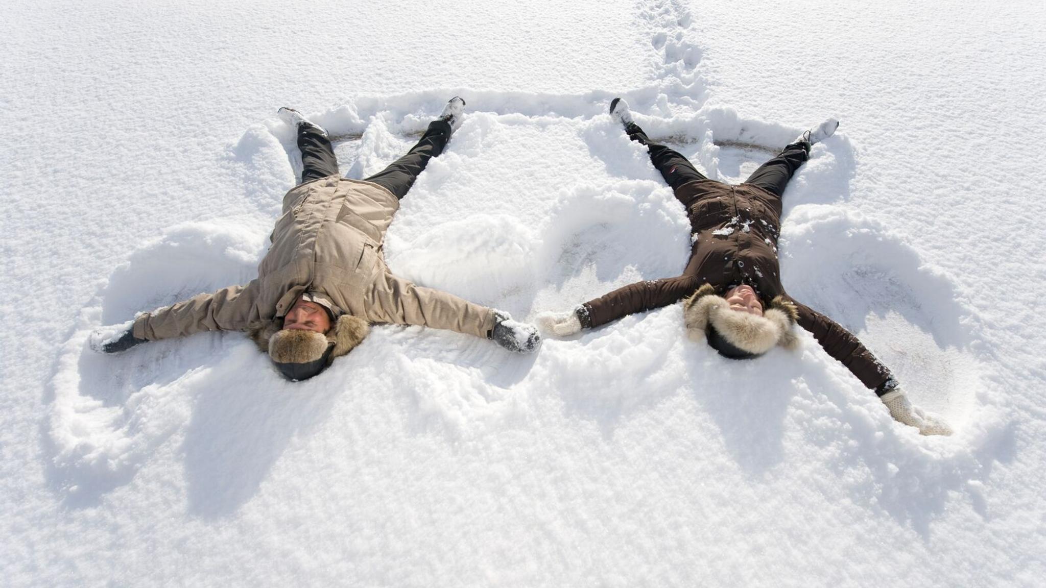 Two people playing in the snow, in Finnmark