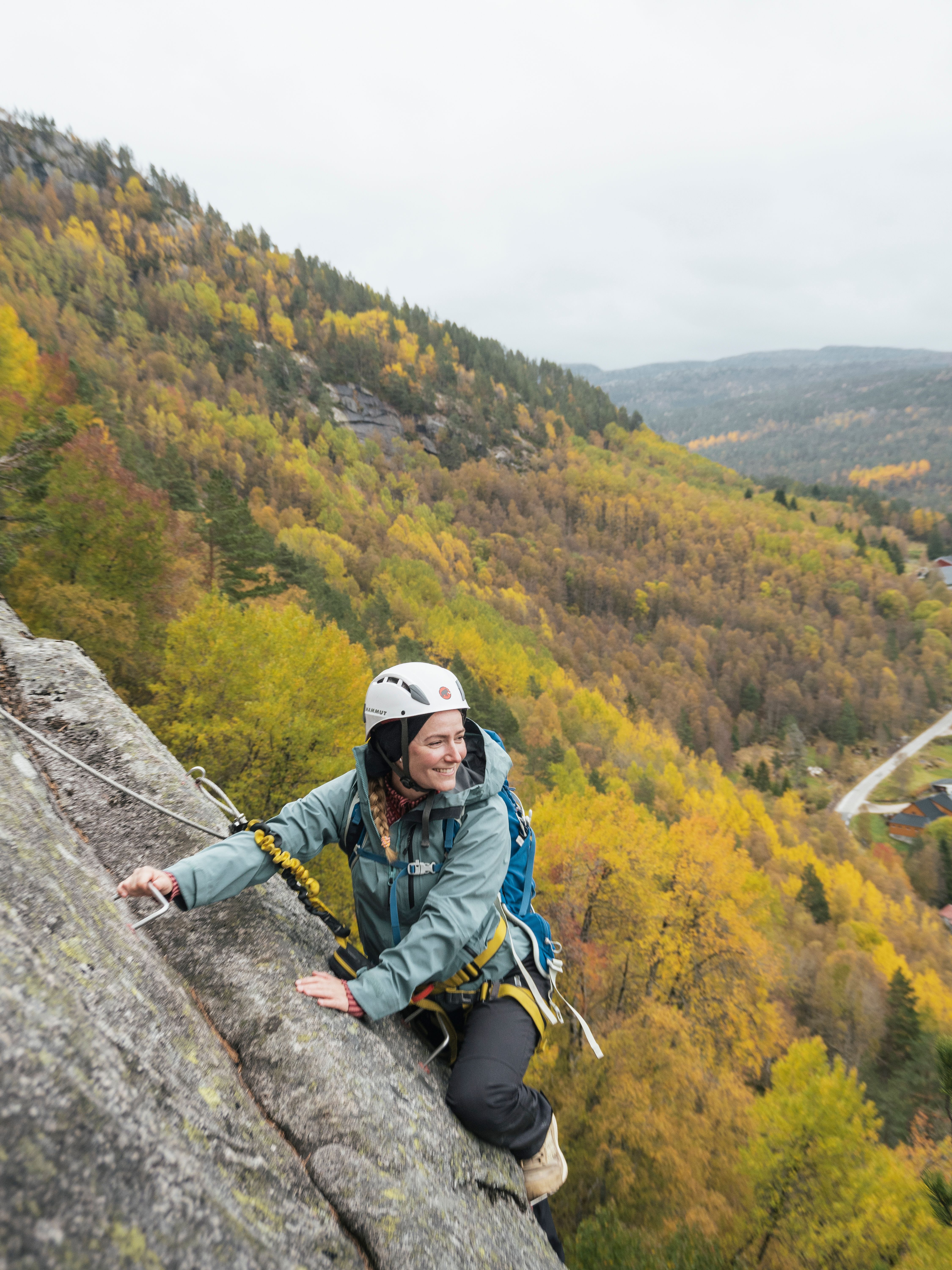 Woman climbing the Via Ferrata in Knaben, Southern Norway