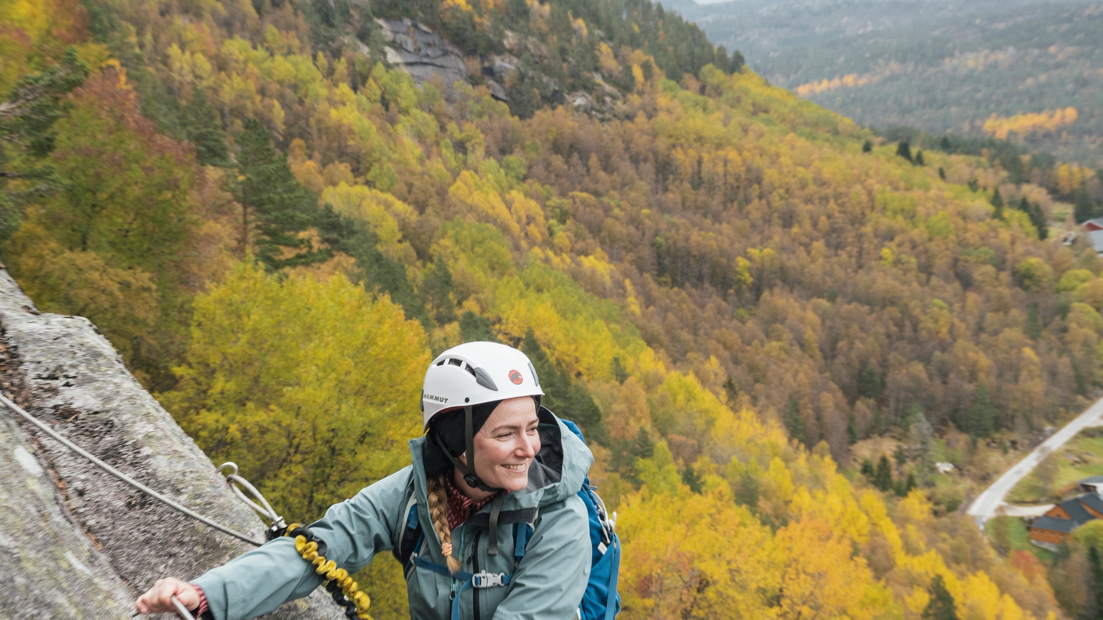 Woman climbing the Via Ferrata in Knaben, Southern Norway