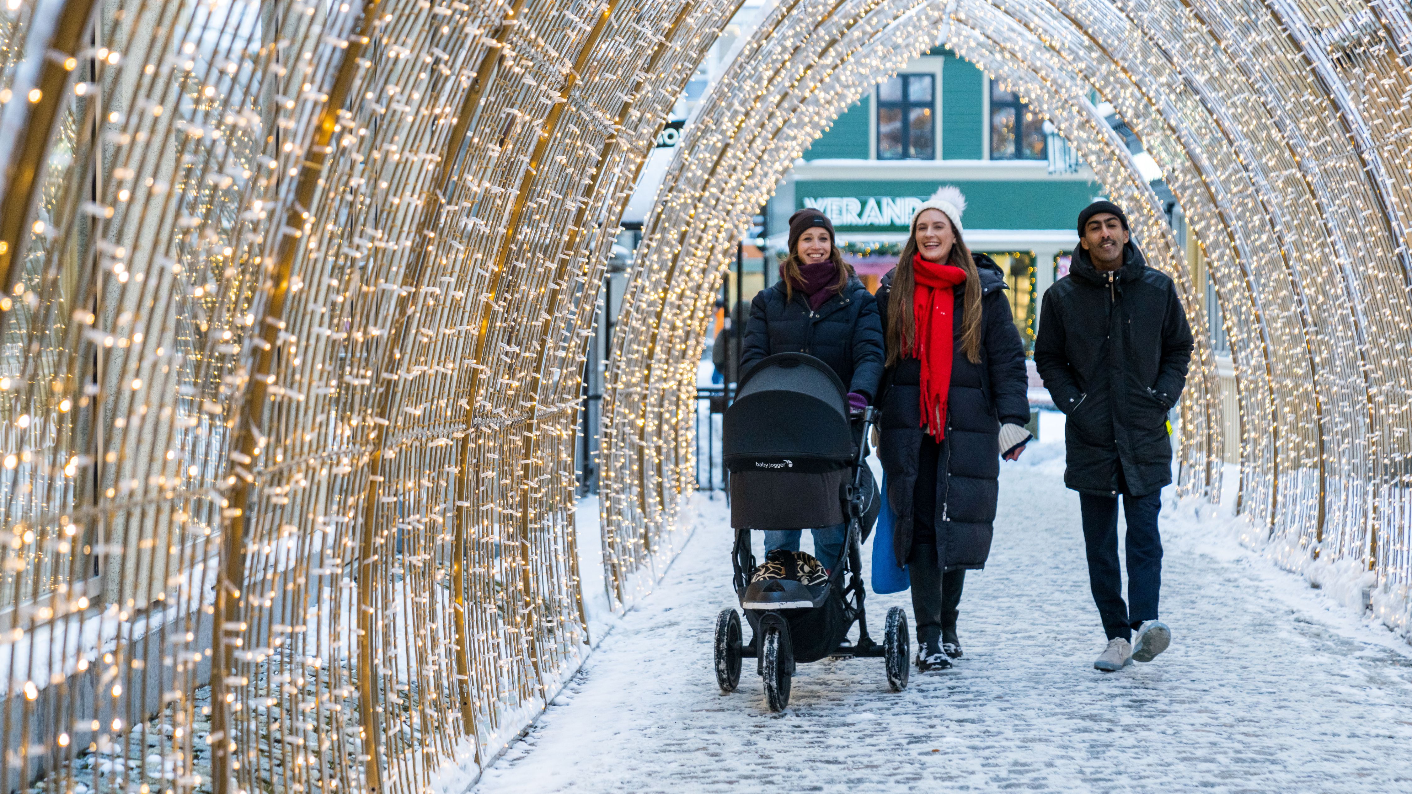 Friends walking in a tunell of lights in Trondheim, Trøndelag, Norway.