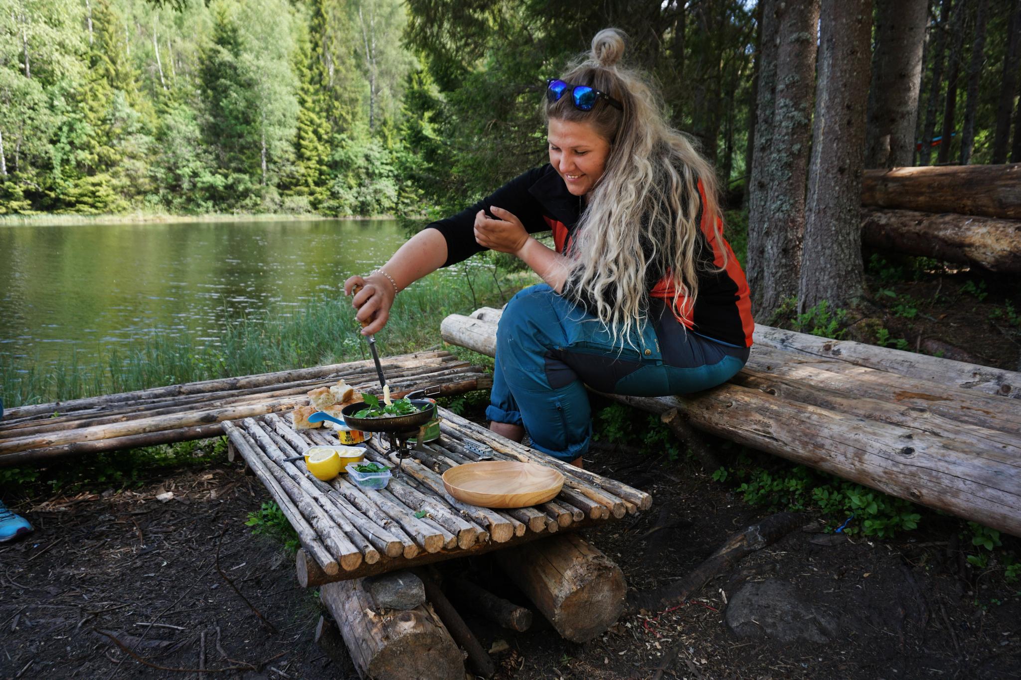 A woman cooking up the catch after freshwater fishing in a lake in Akershus, Eastern Norway