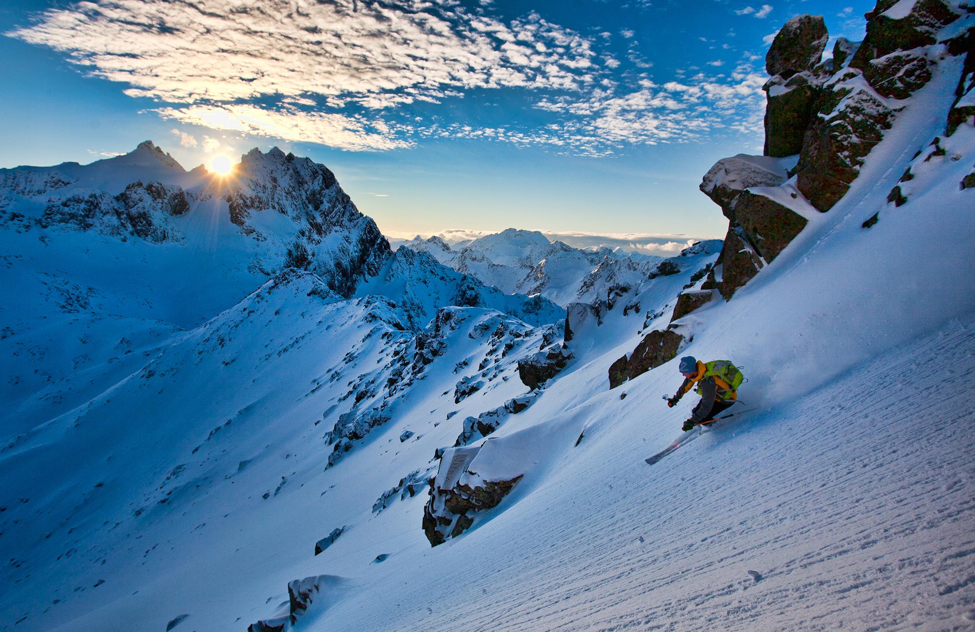 Skiing down snow-capped mountain near Standalseidet in Ørsta, Fjord Norway