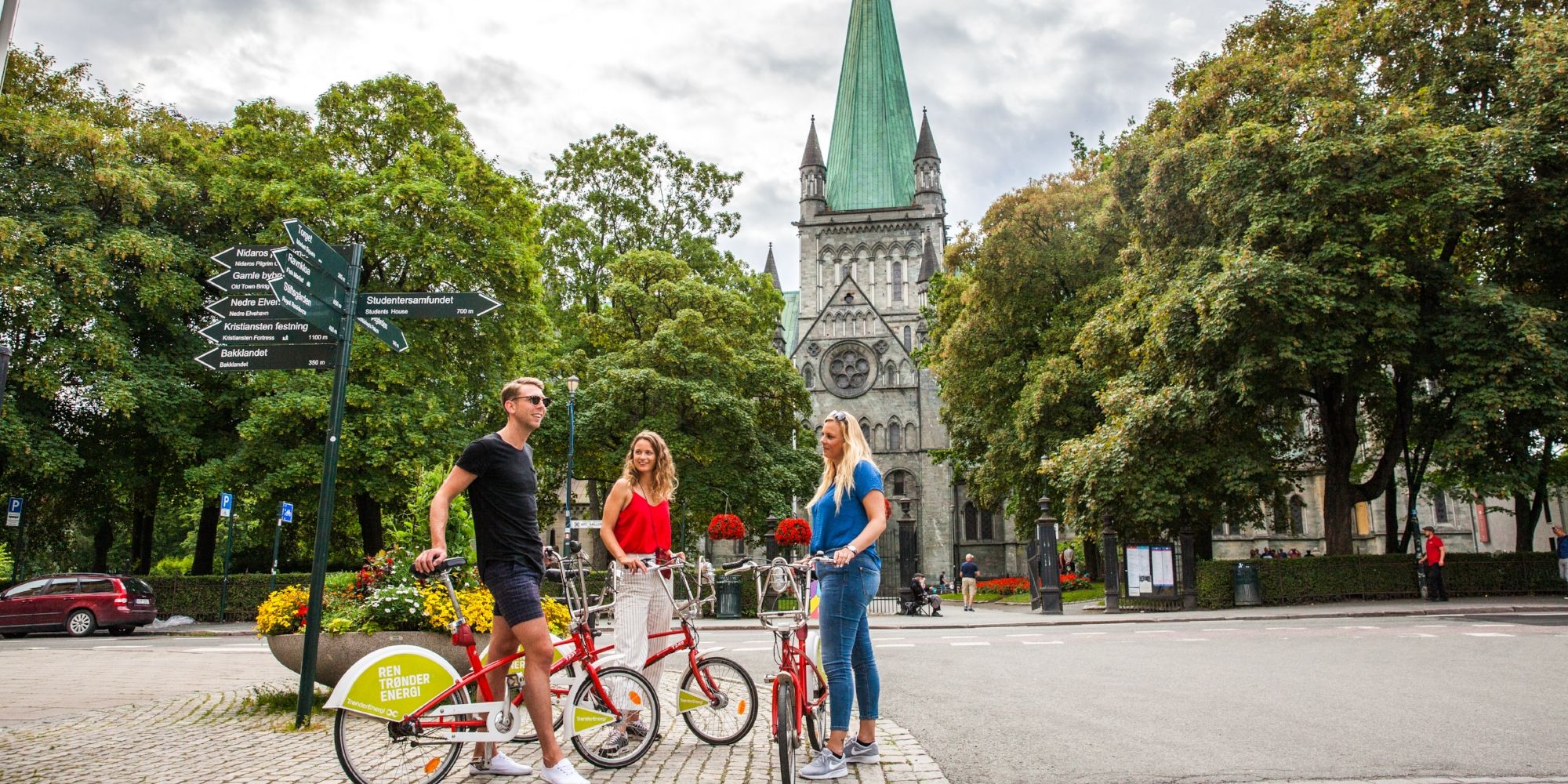 Three people with bikes on a city break in Trondheim, Norway