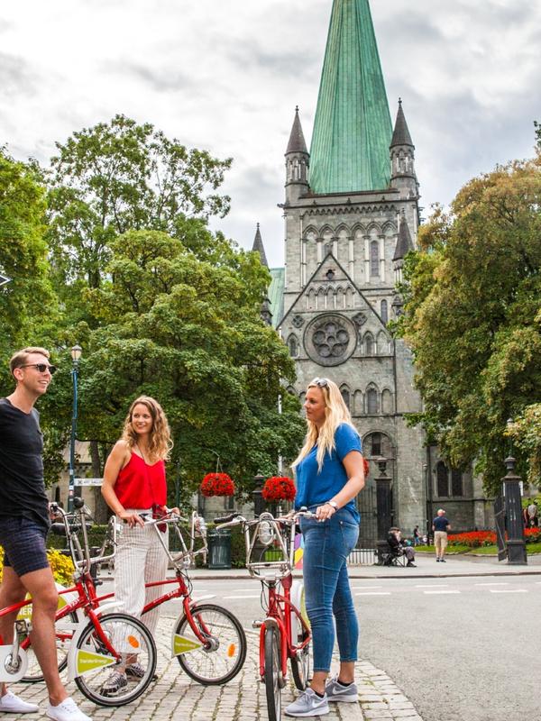 Three people with bikes on a city break in Trondheim, Norway