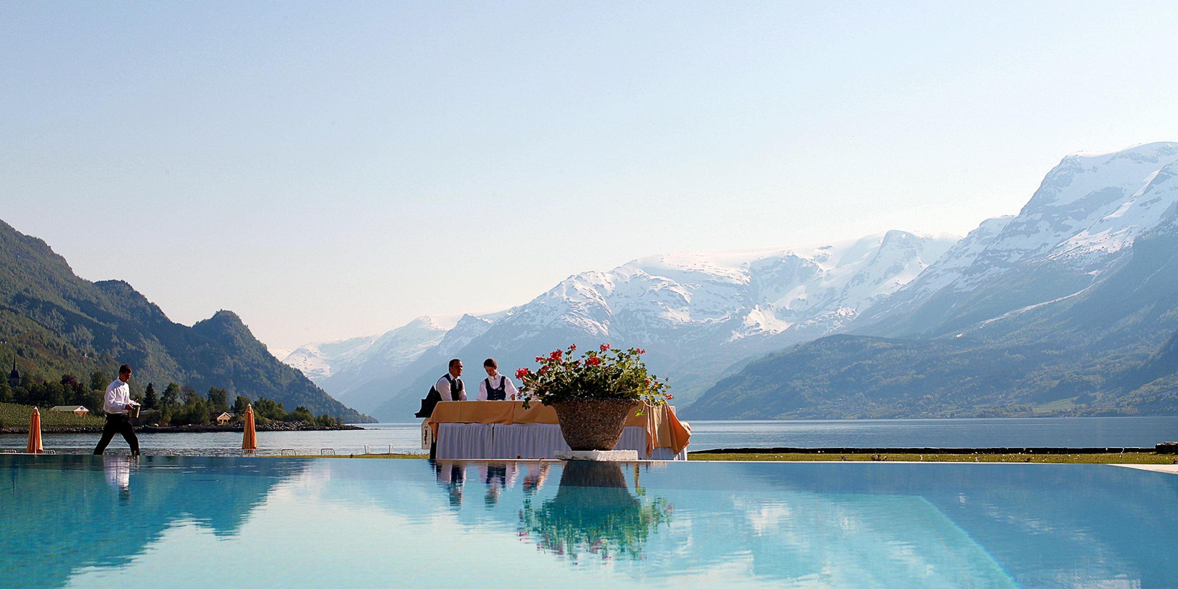 The pool at Hotel Ullensvang in Lofthus, Norway, with the mountains and the Hardangerfjord in the background