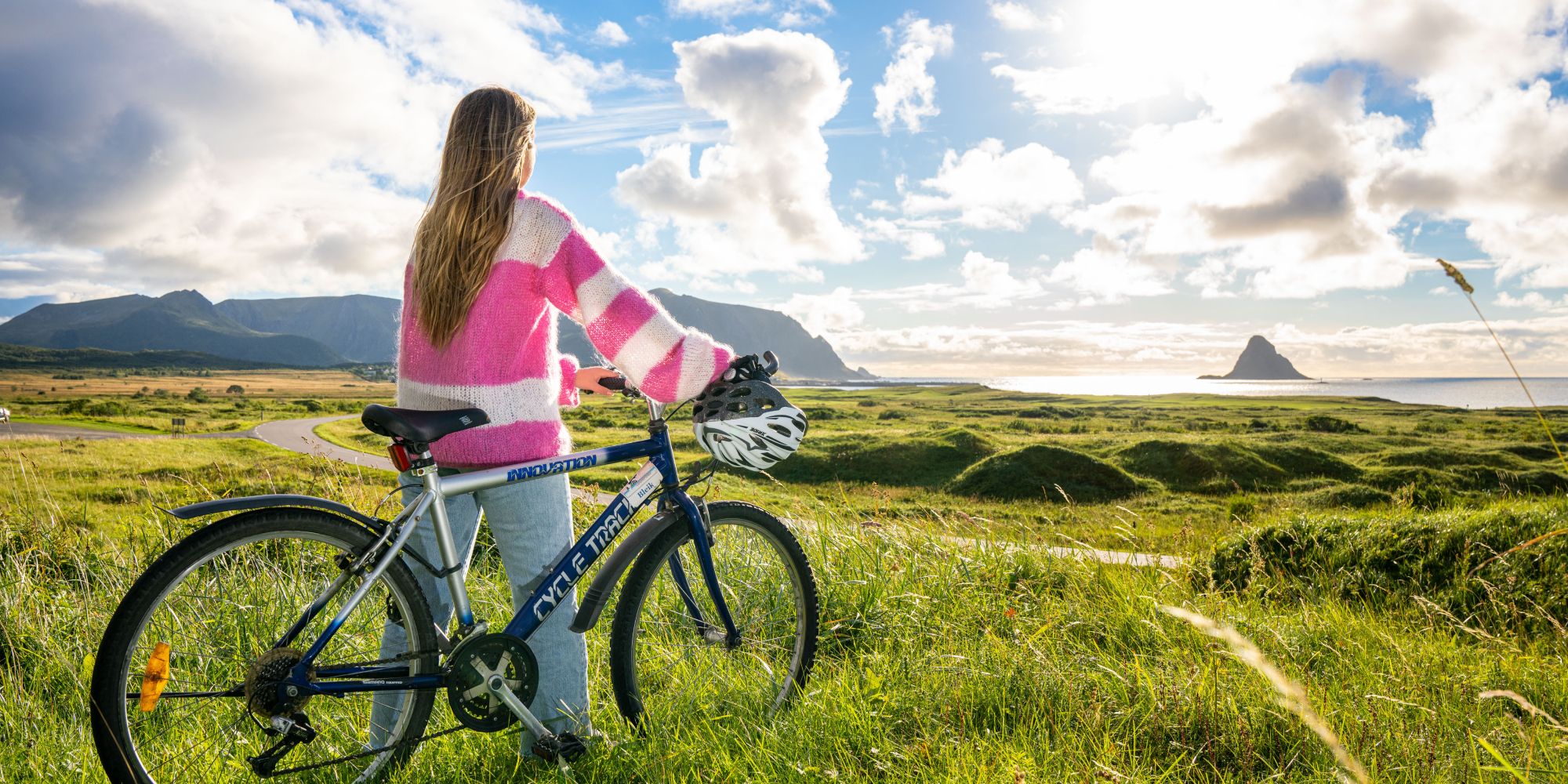 A woman biking along Norwegian Scenic Route Andøya in Vesterålen