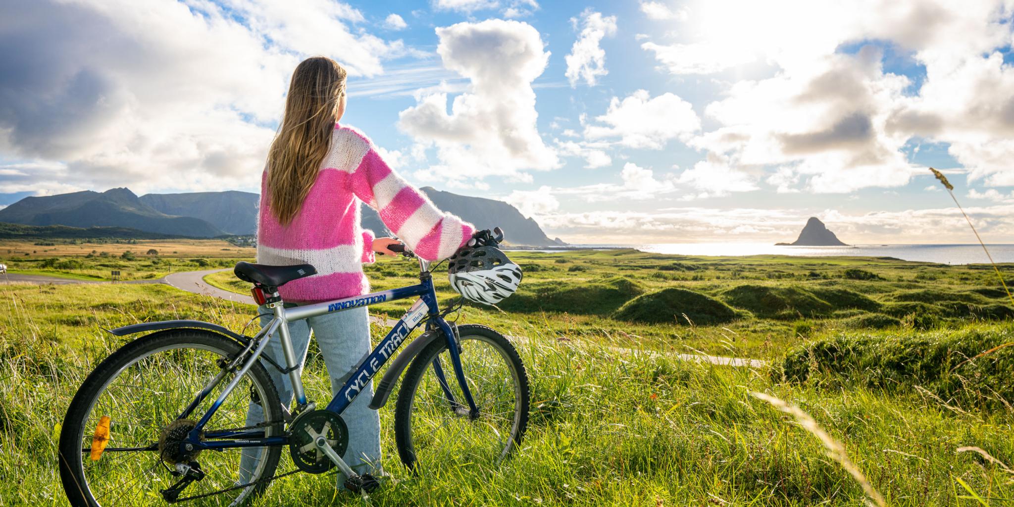 A woman biking along Norwegian Scenic Route Andøya in Vesterålen