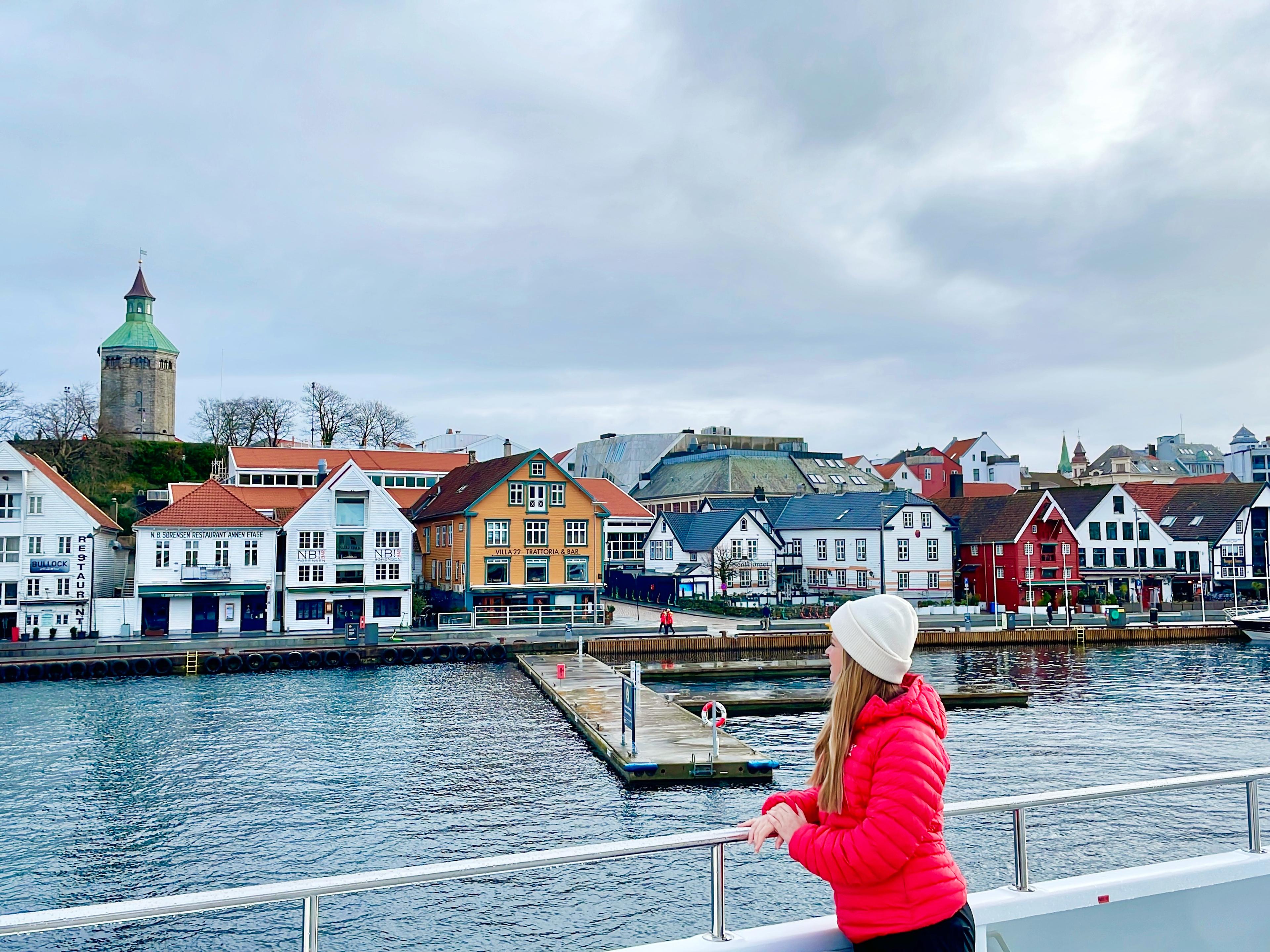 A woman standing on a cruise ship with view to the harbour of Stavanger