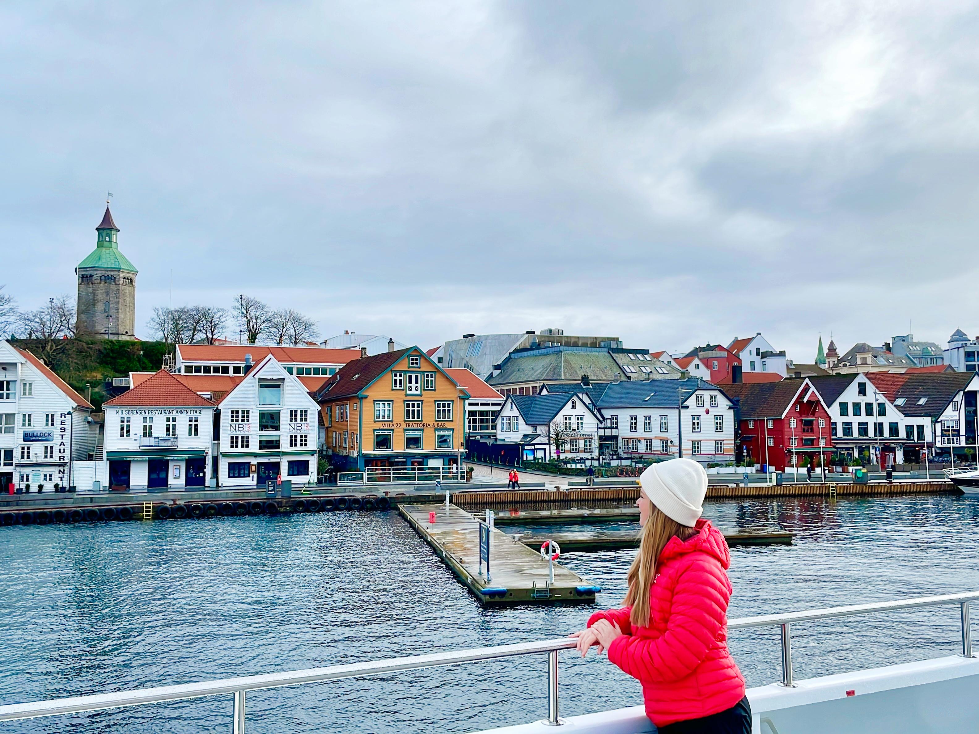 A woman standing on a cruise ship with view to the harbour of Stavanger