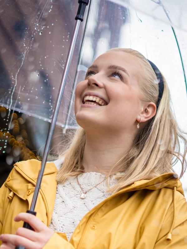Woman with umbrella on a rainy day at Aker Brygge in Oslo, Eastern Norway