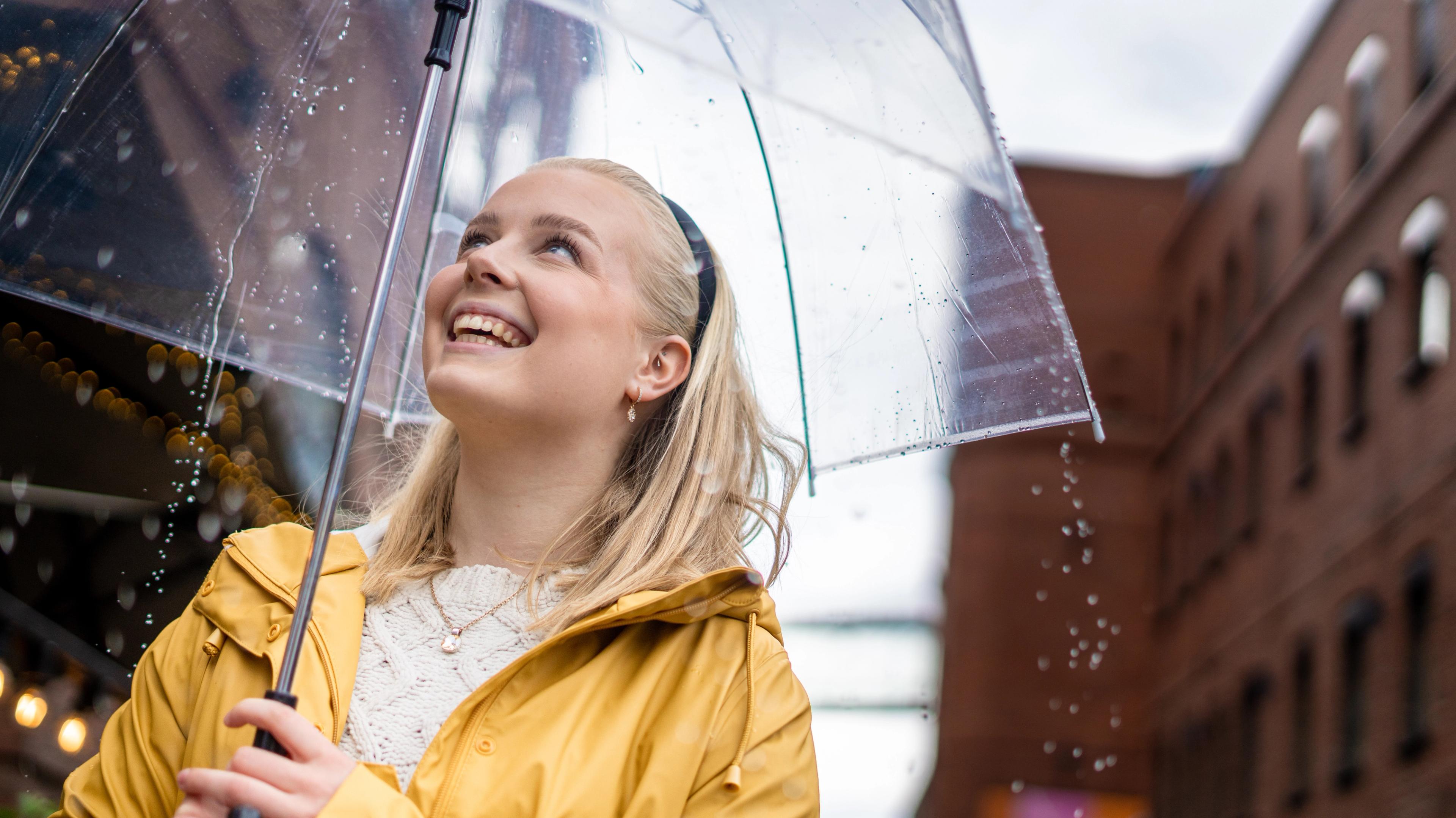 Woman with umbrella on a rainy day at Aker Brygge in Oslo, Eastern Norway