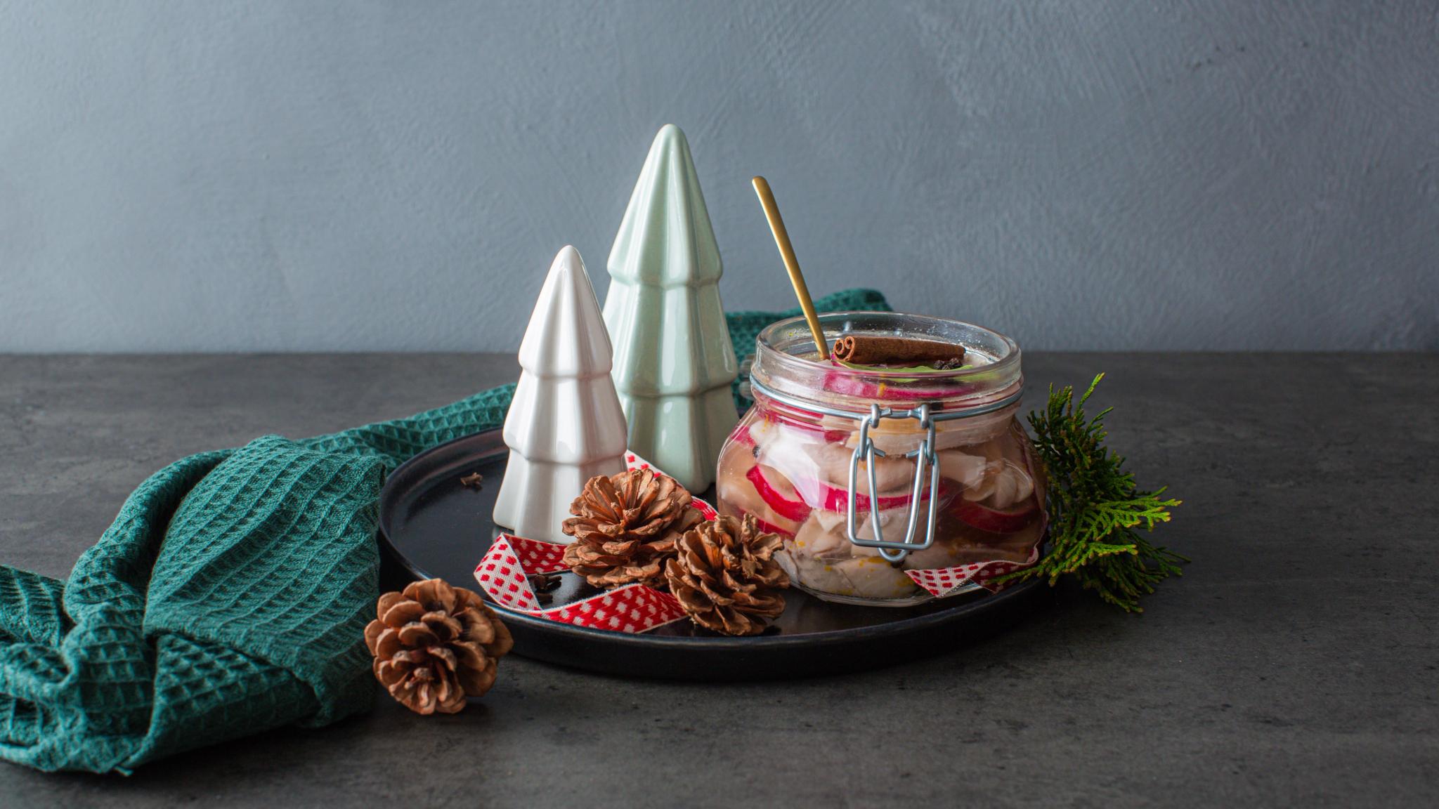 Traditional Norwegian pickled herring in a glass jar