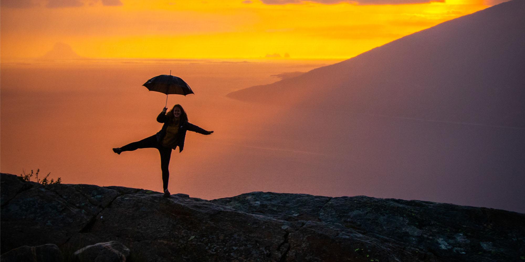 Girl holding an umbrella at the Sjonfjellet mountain in Northern Norway