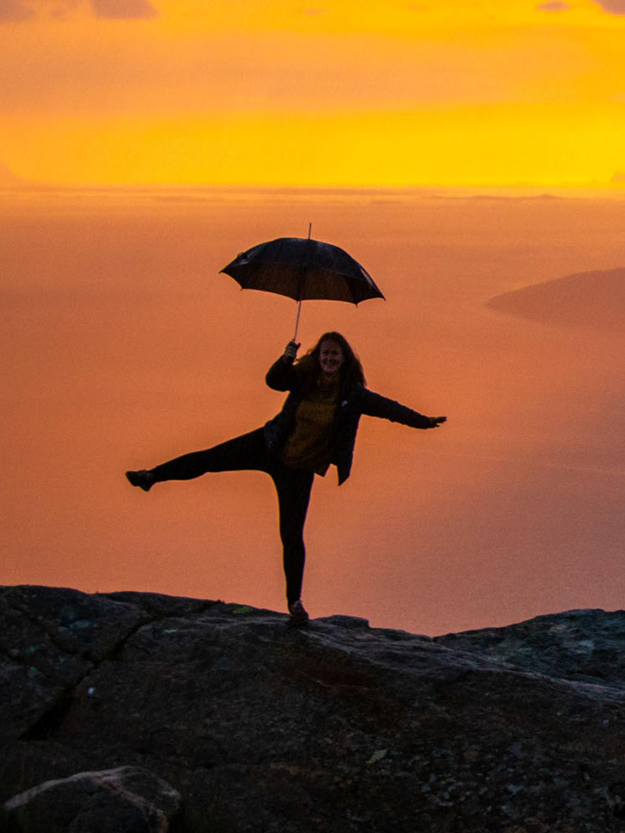 Girl holding an umbrella at the Sjonfjellet mountain in Northern Norway