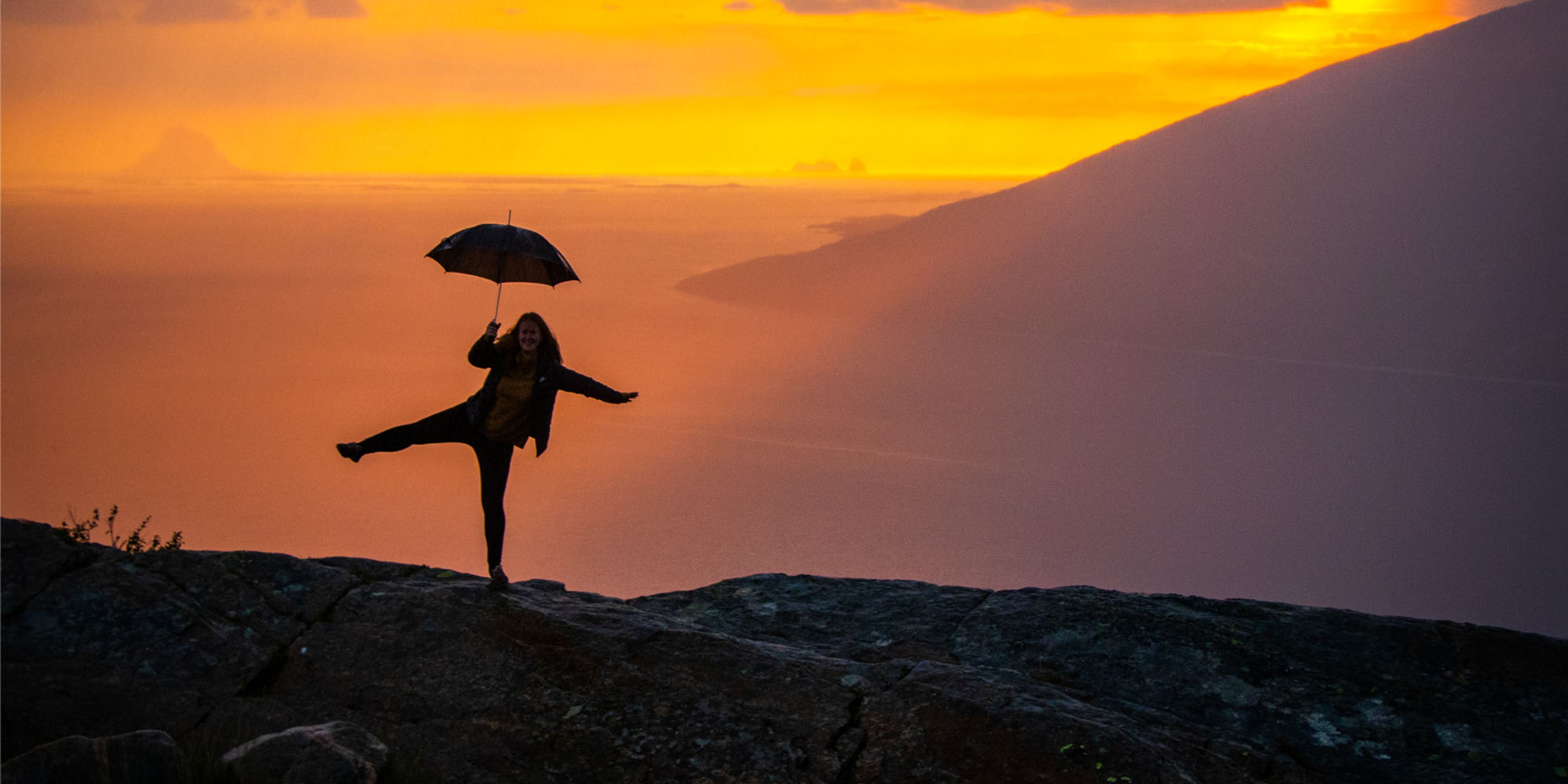 Girl holding an umbrella at the Sjonfjellet mountain in Northern Norway