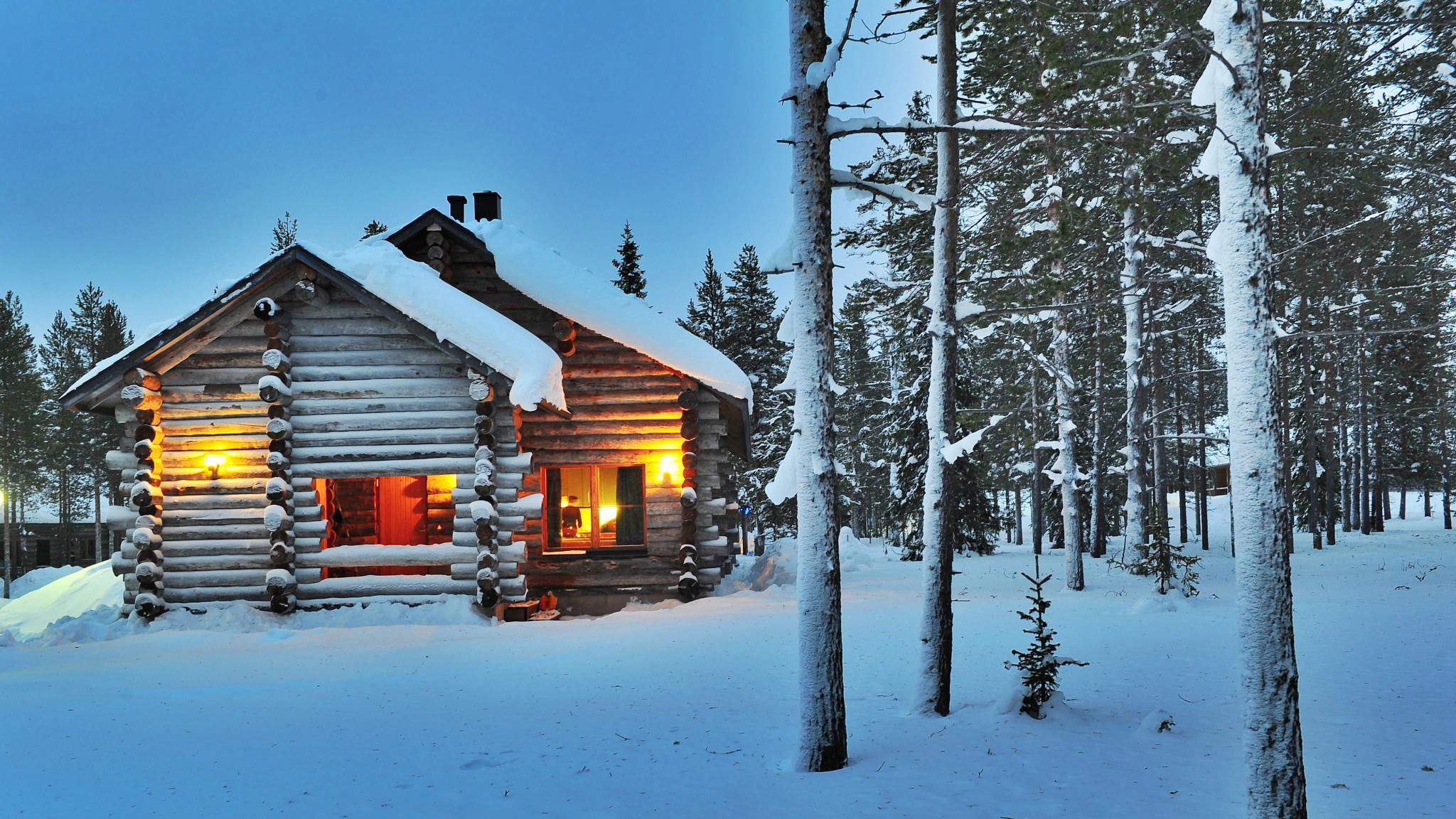 A cabin in the woods in wintertime.
