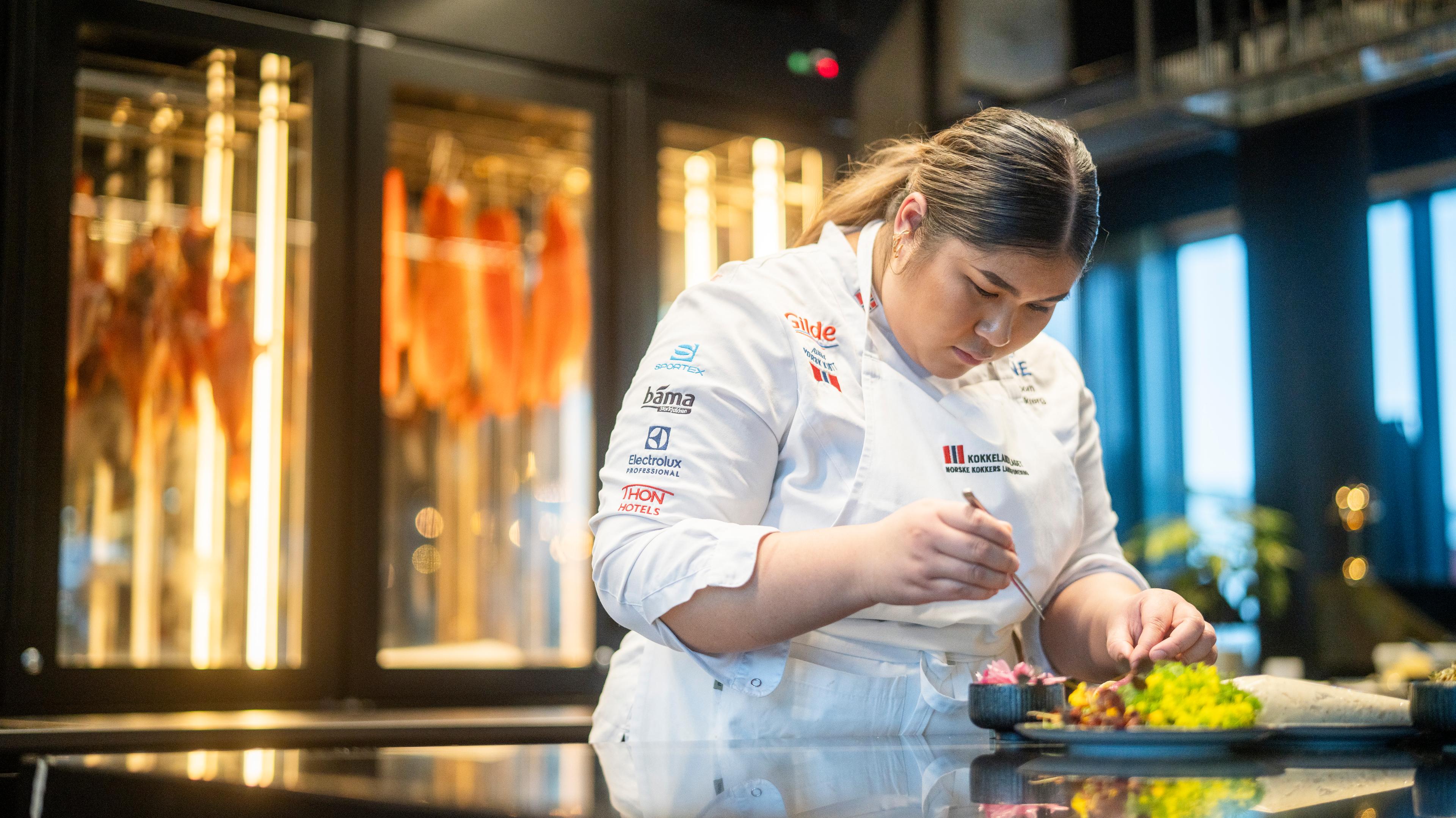 A female chef cooking skrei taco