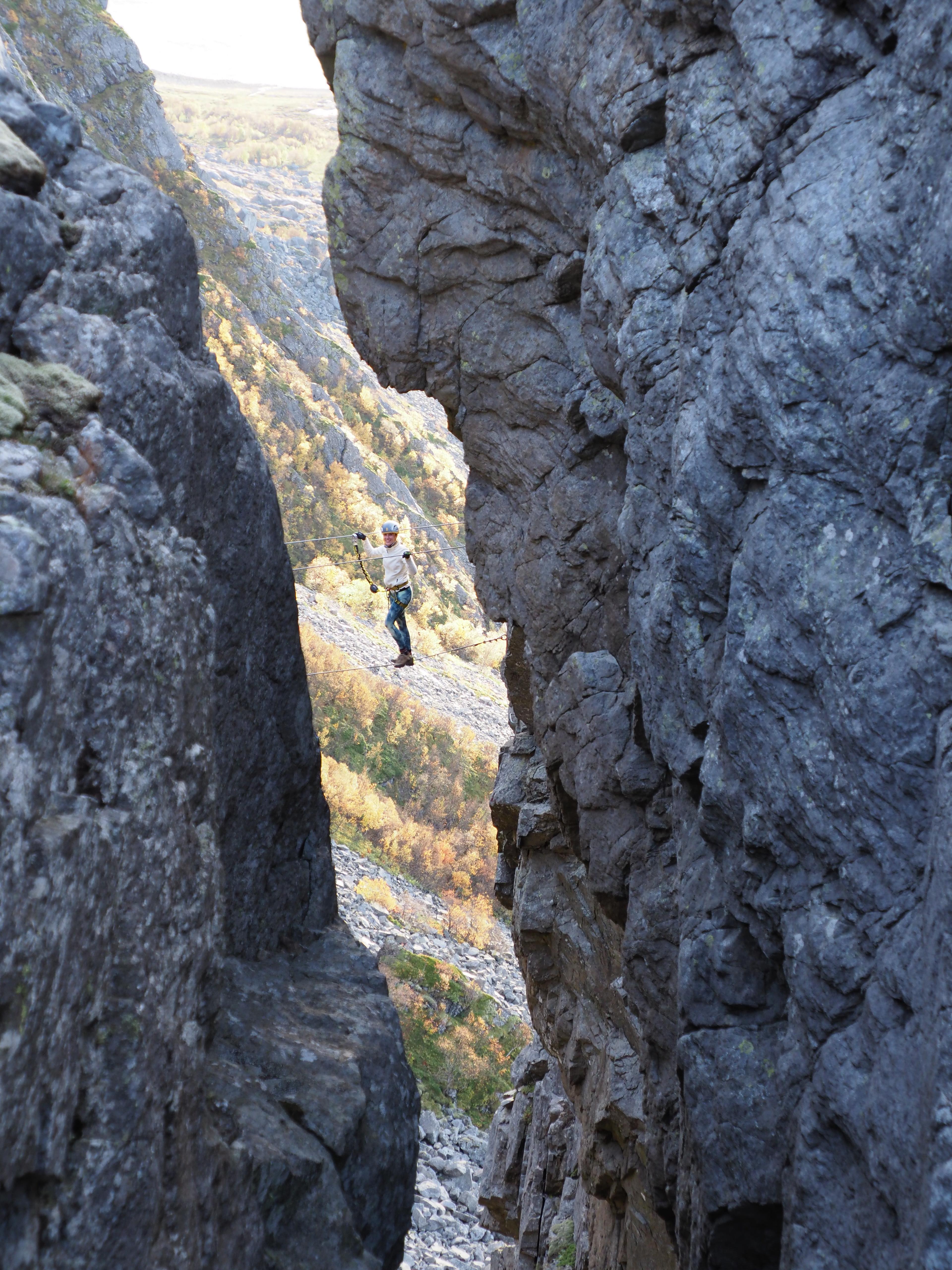 Woman climbing via ferrata Ravnfloget
