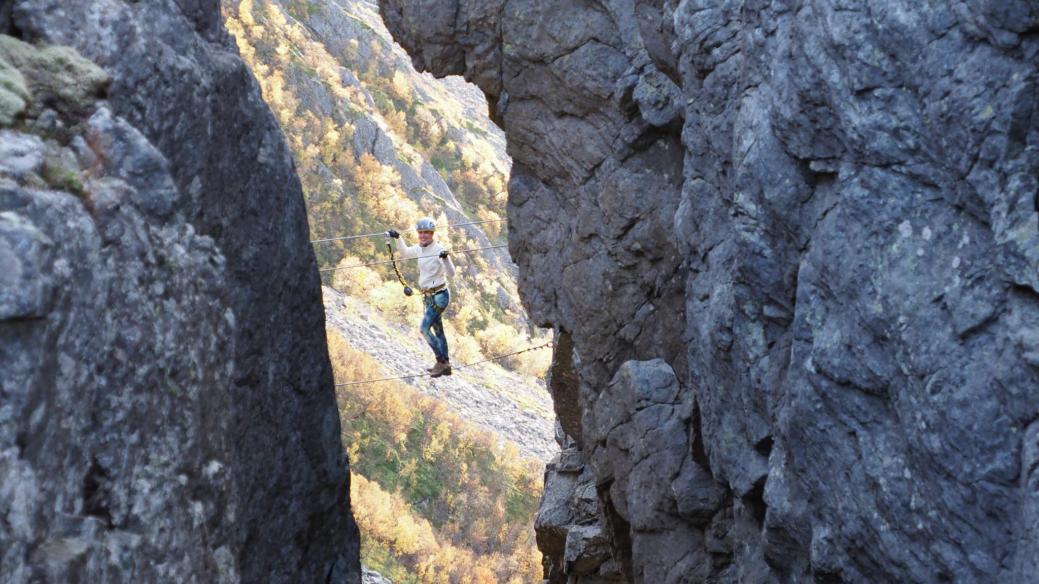 Woman climbing via ferrata Ravnfloget