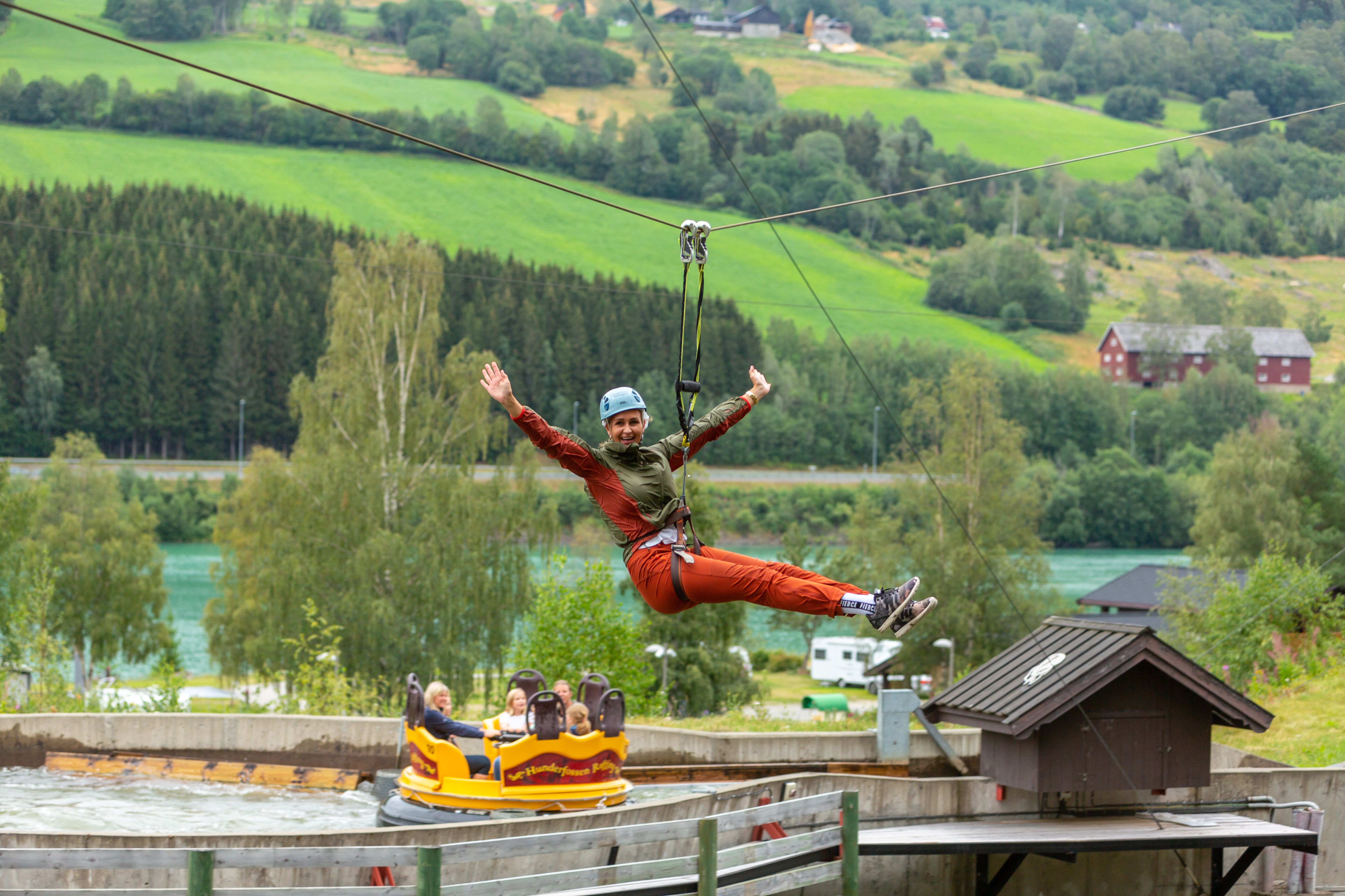 A woman is flying down the zip line in Hunderfossen Adventure Park in Lillehammer, Eastern Norway