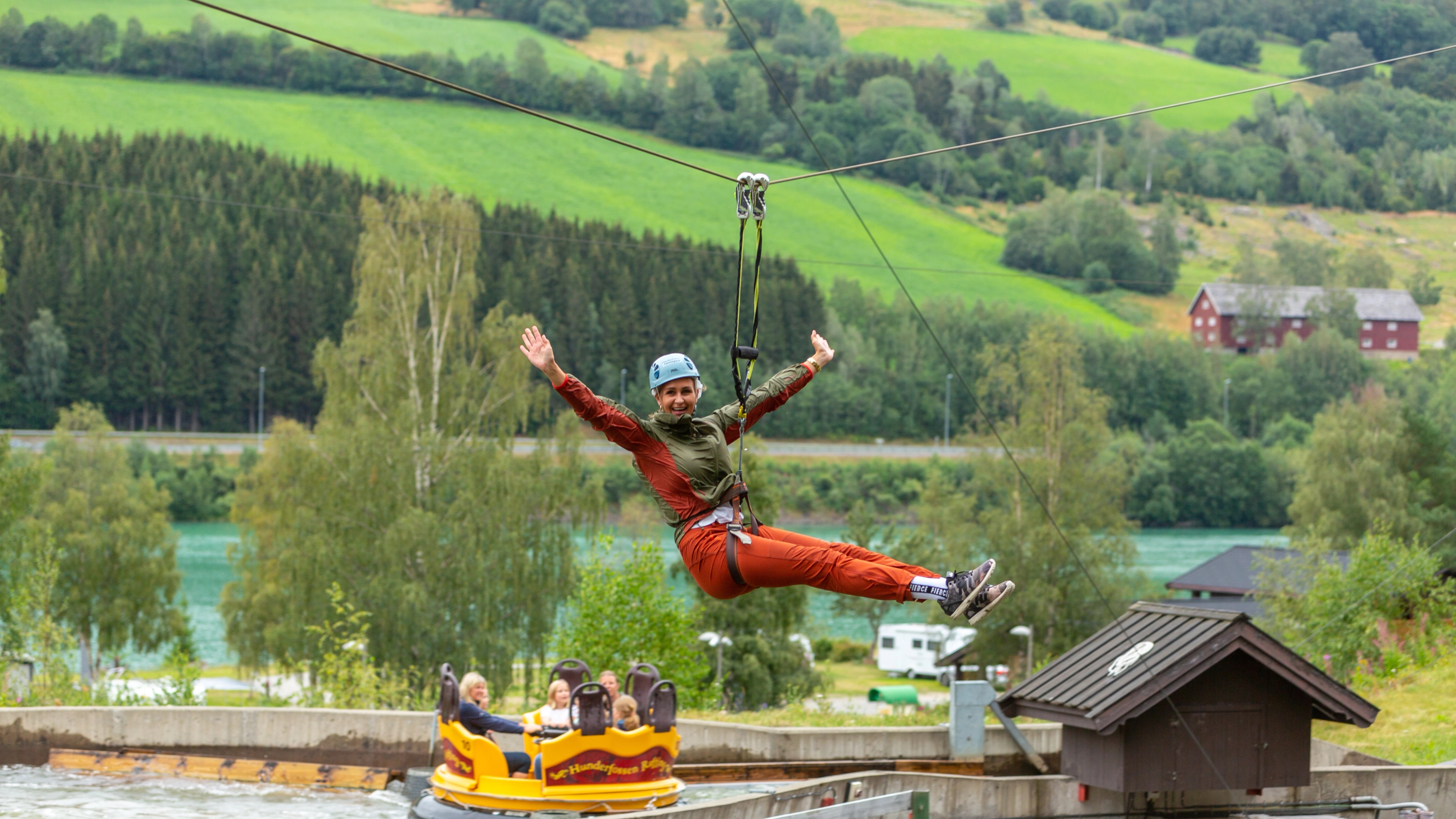 A woman is flying down the zip line in Hunderfossen Adventure Park in Lillehammer, Eastern Norway